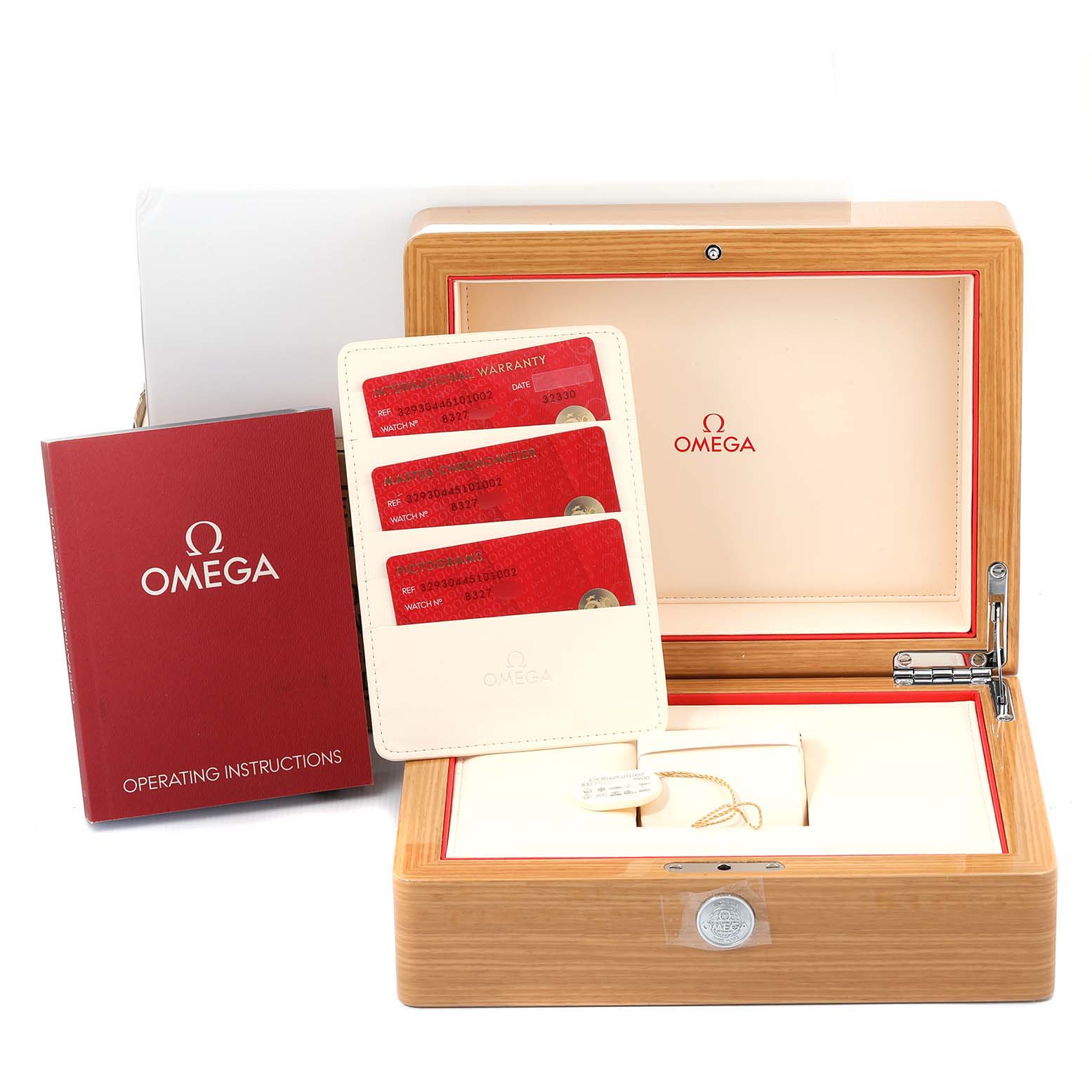 The image shows the packaging for an Omega Speedmaster 329.30.44.51.01.002 Men
s Stainless Steel Black Dial 329.30.44.51.01.002 Men
s Stainless Steel Black Dial watch, including the box, warranty cards, and operating instructions.