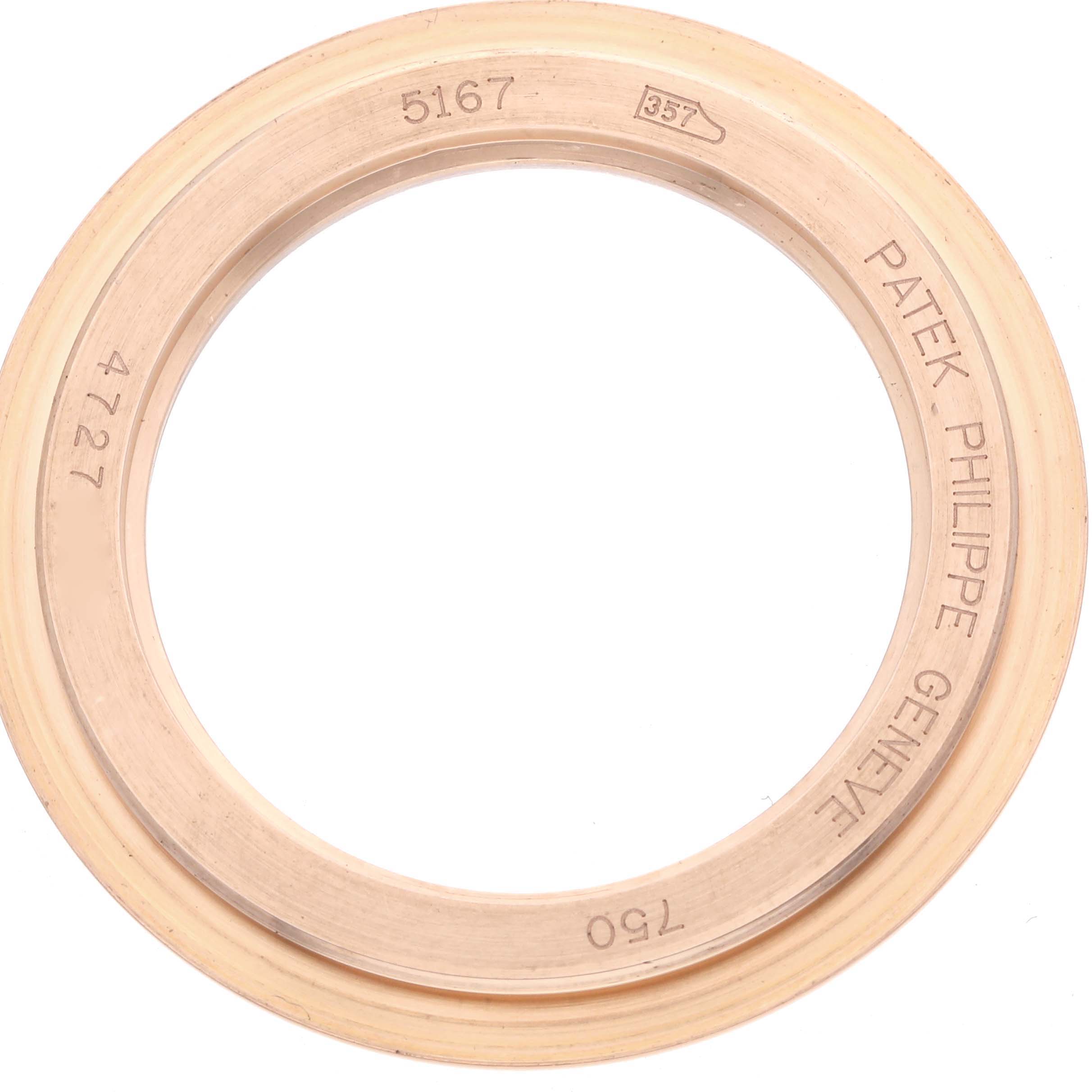 The image shows a Patek Philippe Aquanaut 5167R Men
s Rose Gold Brown Dial watch bezel, viewed from above, displaying engravings and brand markings.