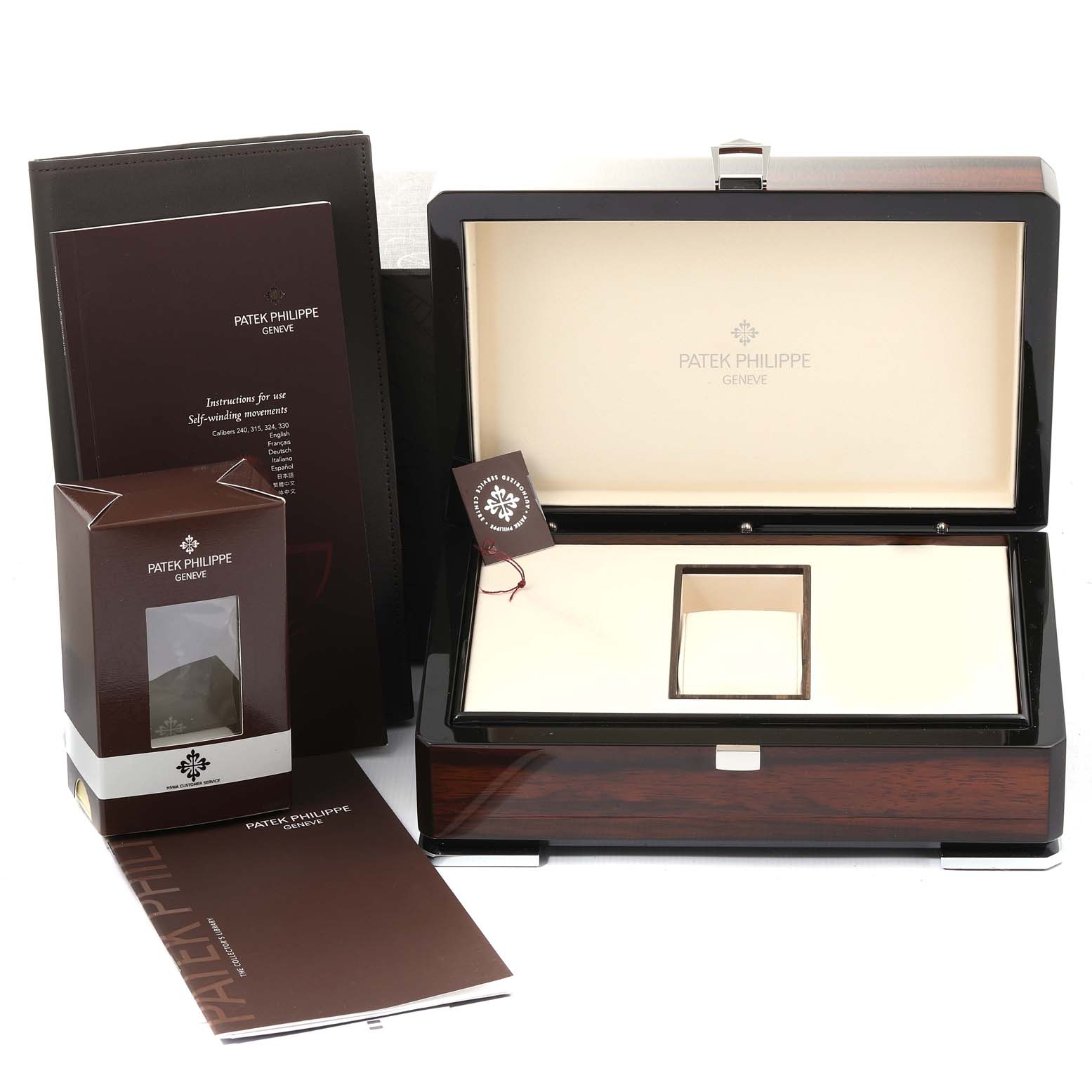 The image shows the Patek Philippe Aquanaut 5167A Men's Stainless Steel Black Dial 5167A Men's Stainless Steel Black Dial watch's packaging, including an open box, manuals, and tags from a frontal angle.