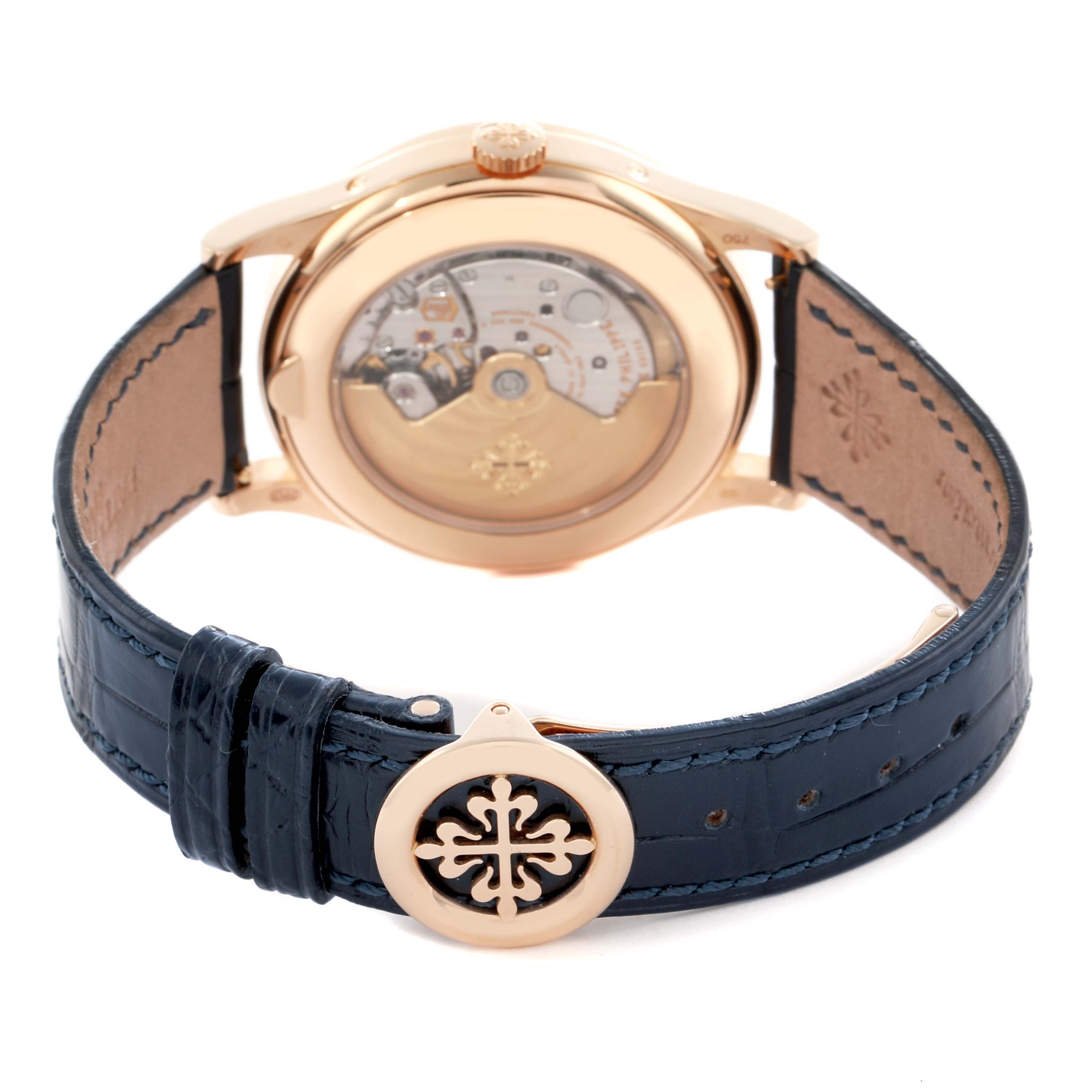 The image shows the back view of a Patek Philippe Complications 5396R Men
s Rose Gold Blue Dial watch, highlighting the movement and strap clasp.