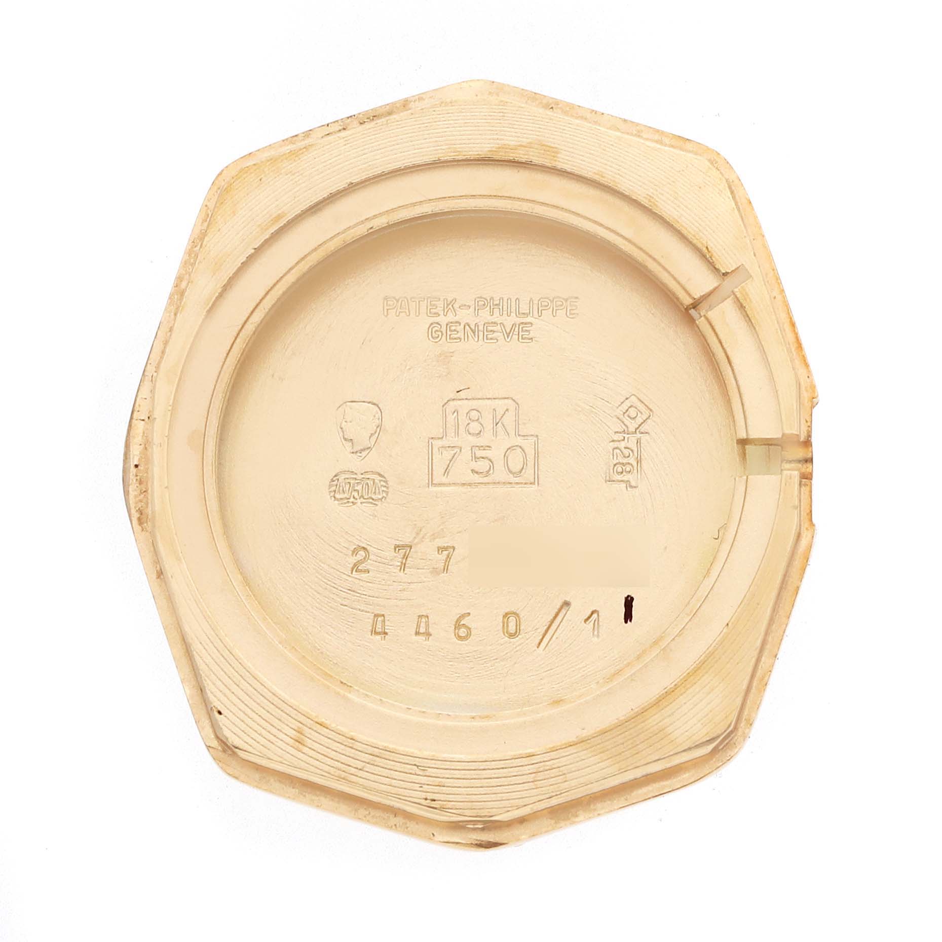 This image shows the interior of the case back of a Vintage Patek Philippe watch, detailing engravings and hallmark symbols.
