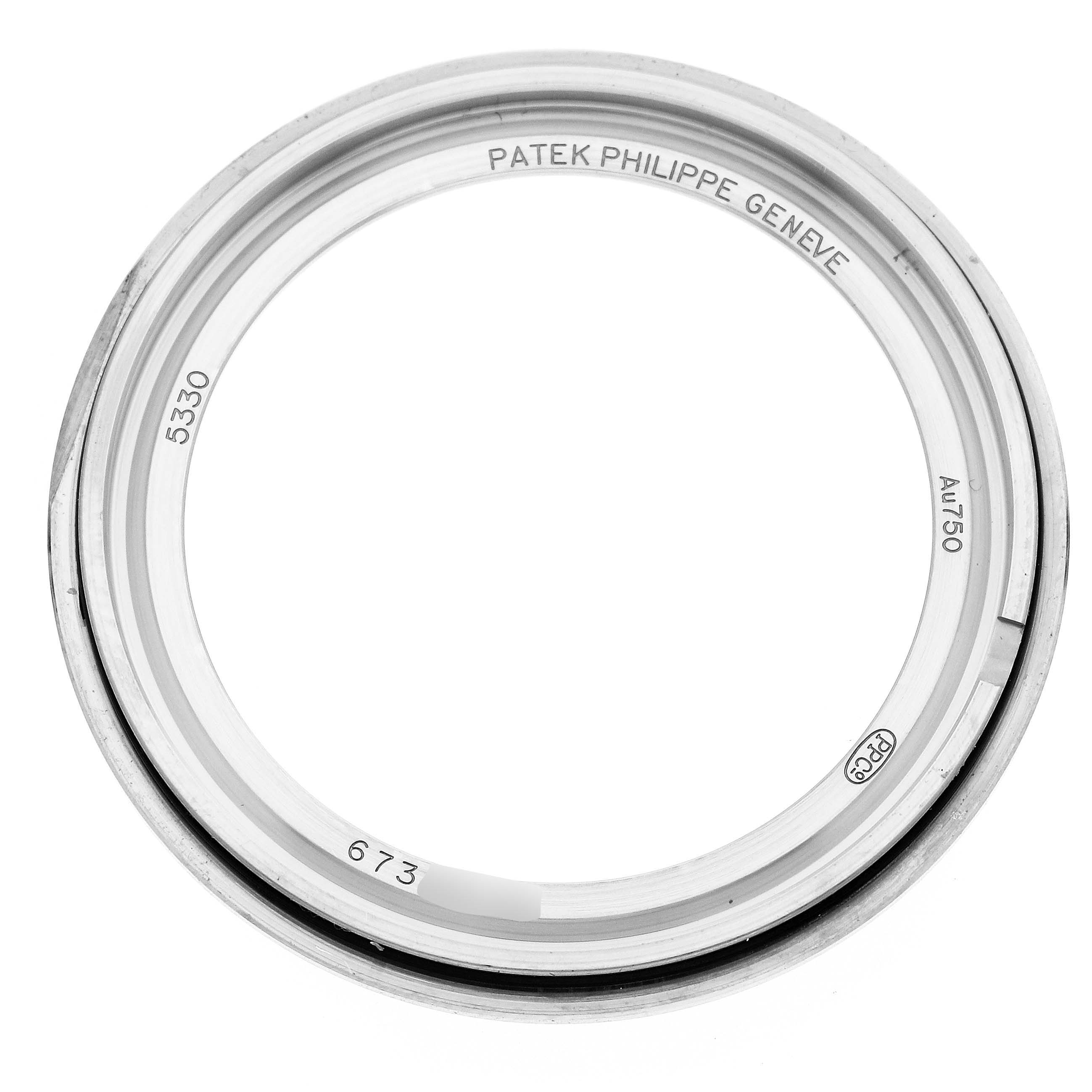 The image shows a top view of the bezel for a Patek Philippe Complications 5330G Men
s White Gold Blue Dial model, displaying inscriptions and markings.