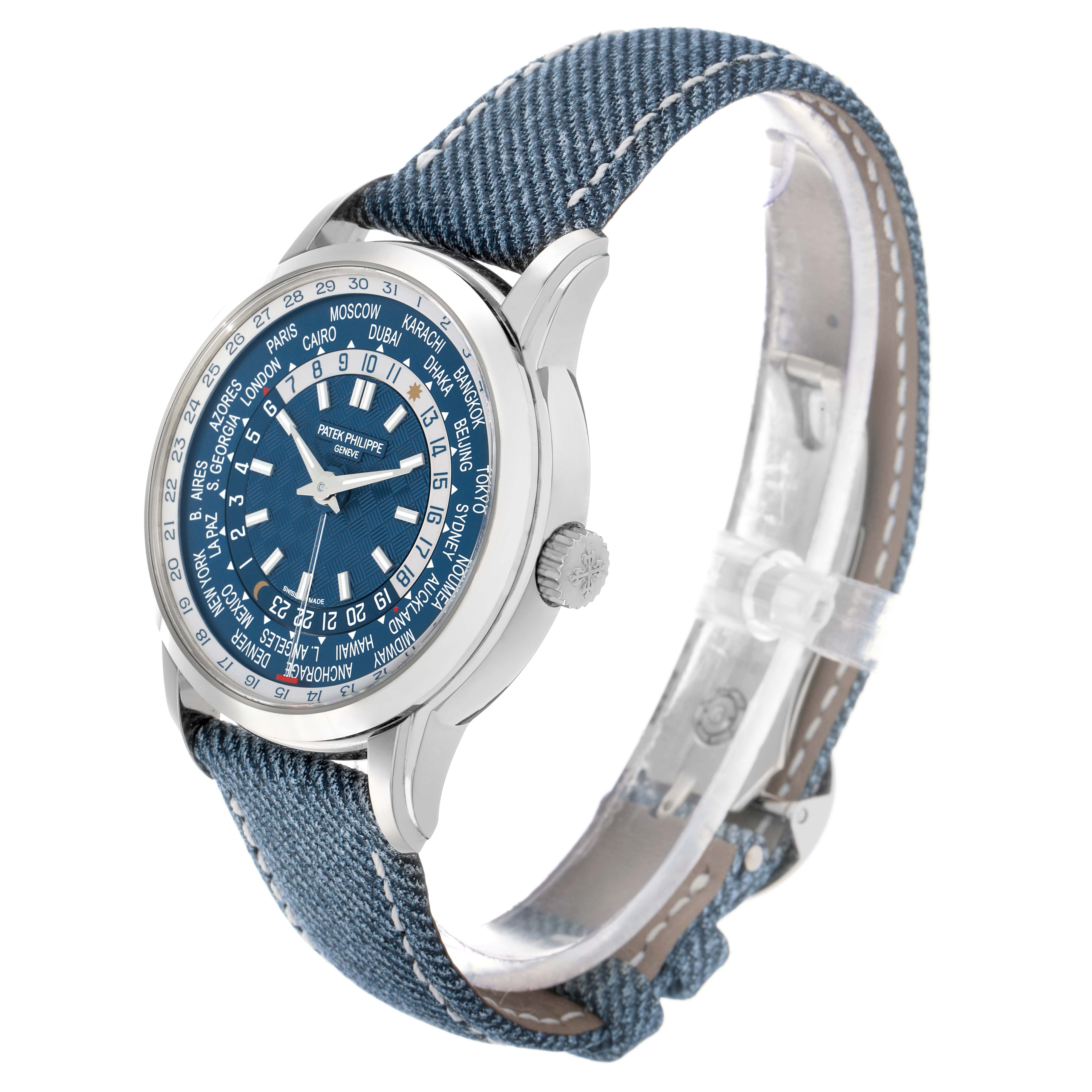 The Patek Philippe Complications 5330G Men
s White Gold Blue Dial watch is shown at an angled side view, highlighting the case, crown, and denim-like strap.