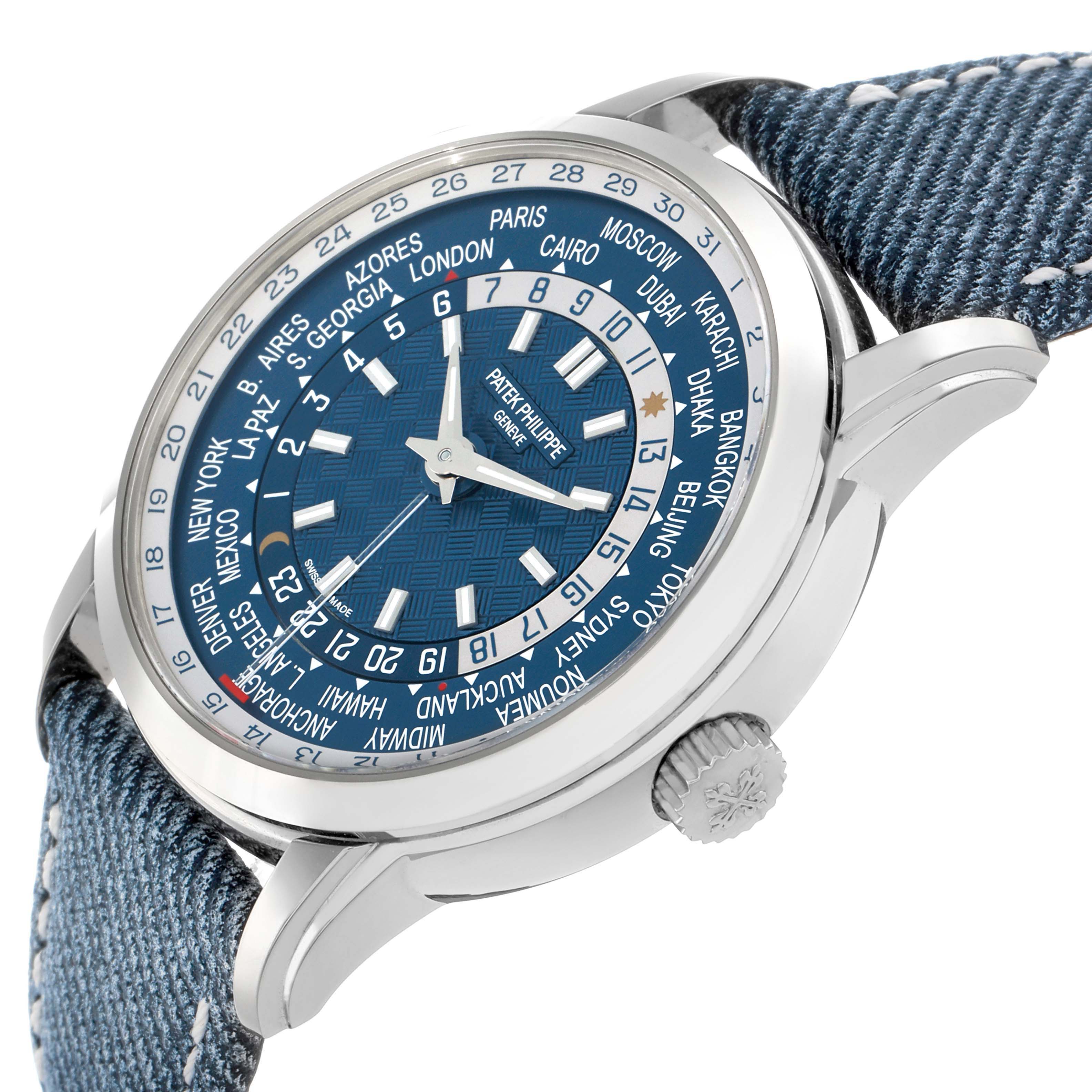 The Patek Philippe Complications 5330G Men
s White Gold Blue Dial watch is shown from a side angle, highlighting the face, dial, cities display, and crown with a blue strap.