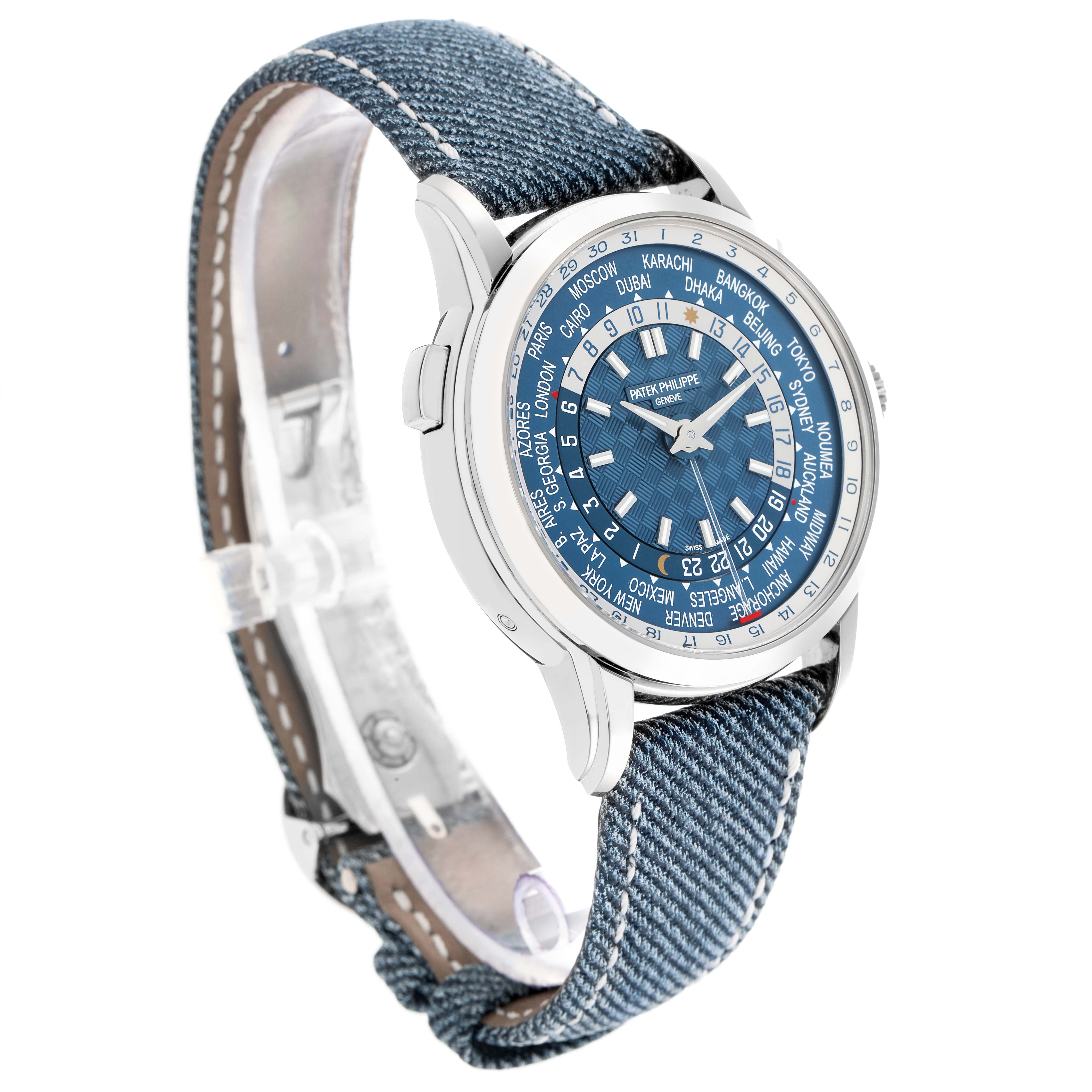 The Patek Philippe Complications 5330G Men's White Gold Blue Dial watch is shown at an angle highlighting its face, bezel, and denim strap.