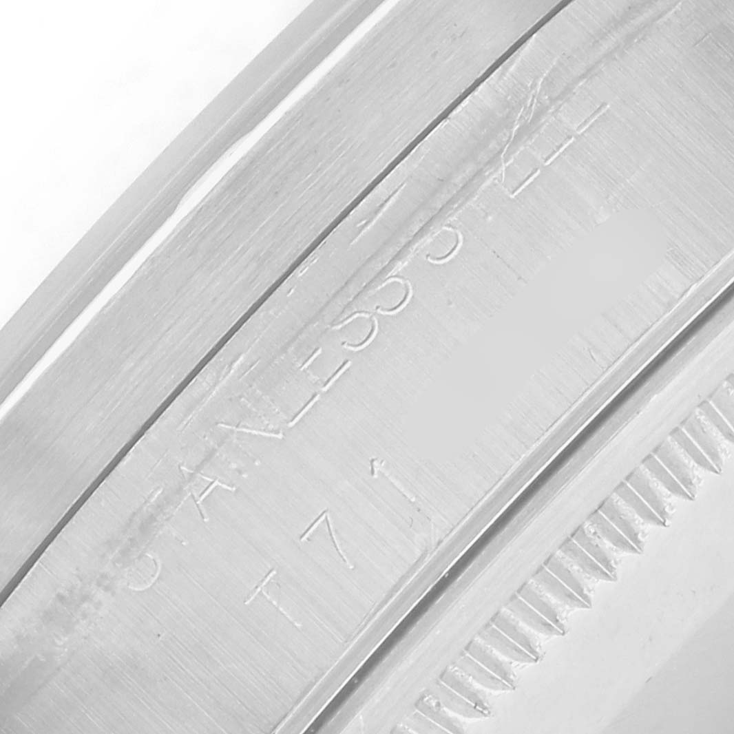 The image shows a close-up of the Rolex Air-King 14010 Men
s Stainless Steel Blue Dial watch
s stainless steel bezel and case edge at an angle.