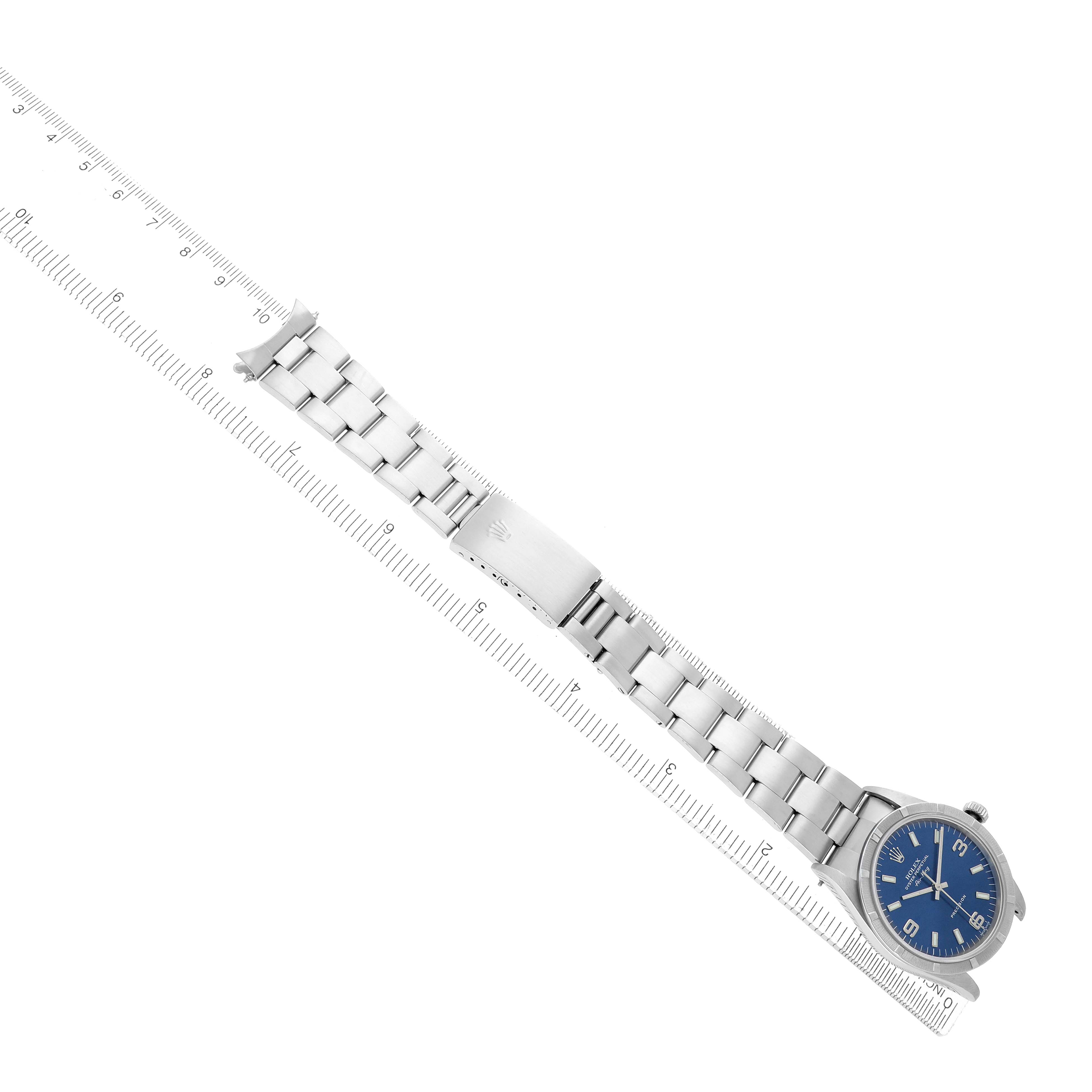 The Rolex Air-King 14010 Men
s Stainless Steel Blue Dial watch is shown from an overhead angle, displaying its full bracelet and dial with a measuring scale.