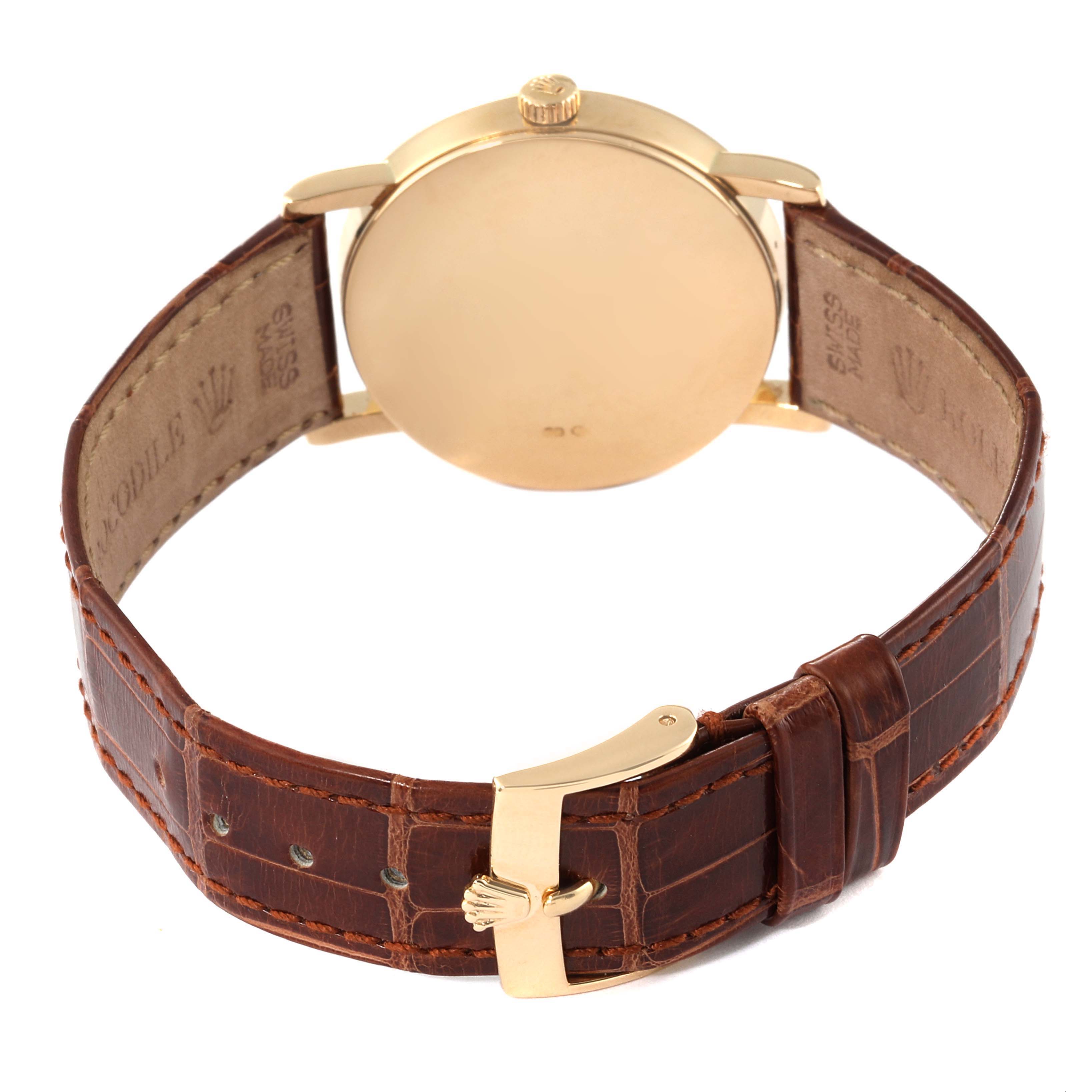 This Rolex Cellini 5115/8 Men's Yellow Gold Silver Dial 5115/8 Men's Yellow Gold Silver Dial watch is shown from the back, highlighting the gold case, crown, brown leather strap, and buckle.