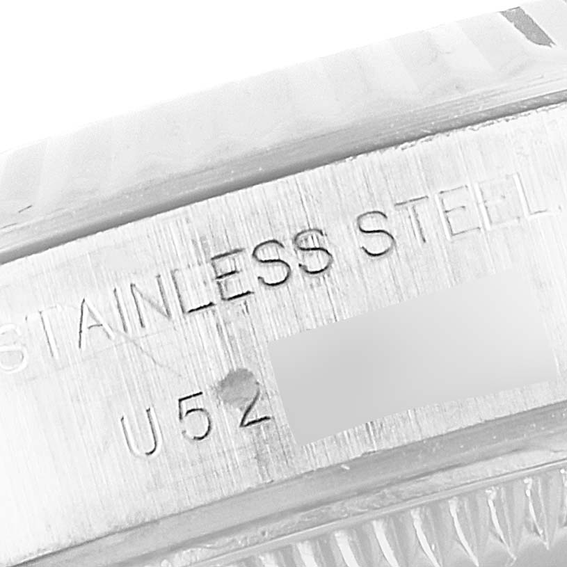 The image shows a close-up view of the side of a Rolex Datejust 69174 Women
s Stainless Steel Silver Dial 69174 Women
s Stainless Steel Silver Dial watch, highlighting the "Stainless Steel" engraving and part of the serial number.
