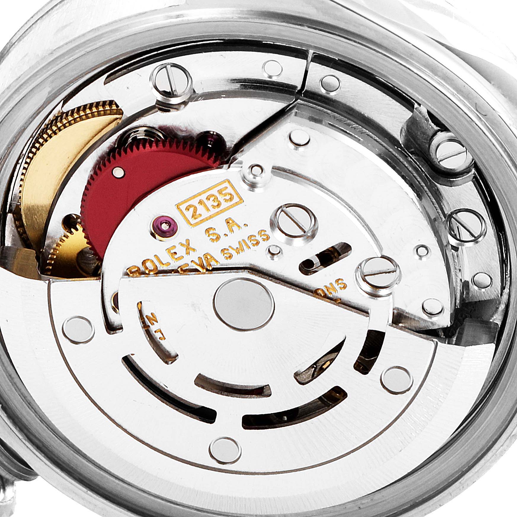 This image shows a close-up of the internal movement mechanism of a Rolex Datejust 69174 Women
s Stainless Steel Silver Dial 69174 Women
s Stainless Steel Silver Dial watch, highlighting gears and inscriptions.