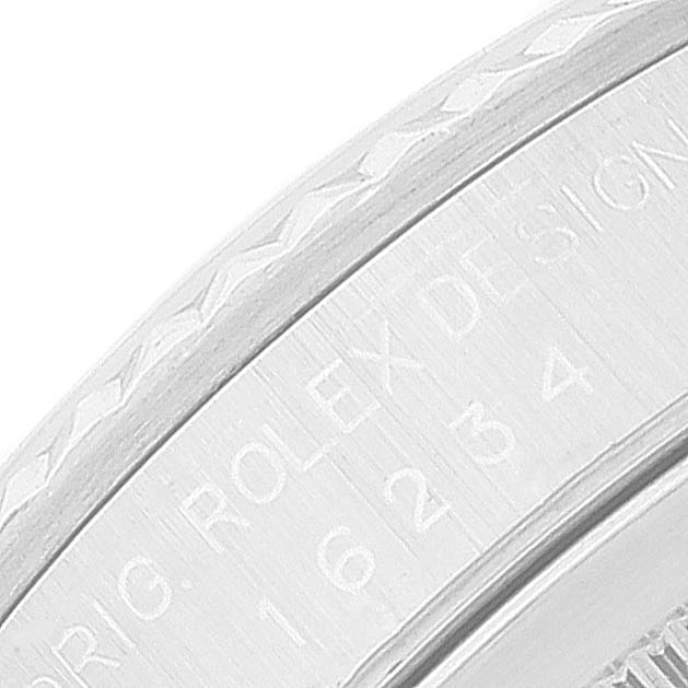 This close-up image shows the side view of the bezel and engraved serial number of a Rolex Datejust 16234 Men's Stainless Steel Black Dial 16234 Men's Stainless Steel Black Dial watch.