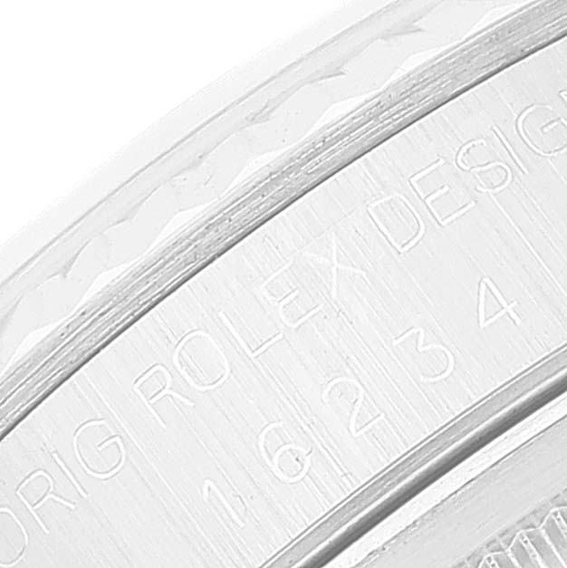 The image shows a close-up of the engraved bezel of a Rolex Datejust 16234 Men's Stainless Steel Silver Dial 16234 Men's Stainless Steel Silver Dial watch.