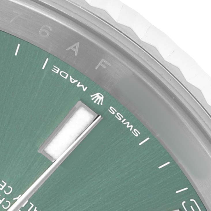 The image shows a close-up angle of the Rolex Datejust 41 126334 Men's Stainless Steel Green Dial, focusing on the dial, bezel, and part of an index marker.