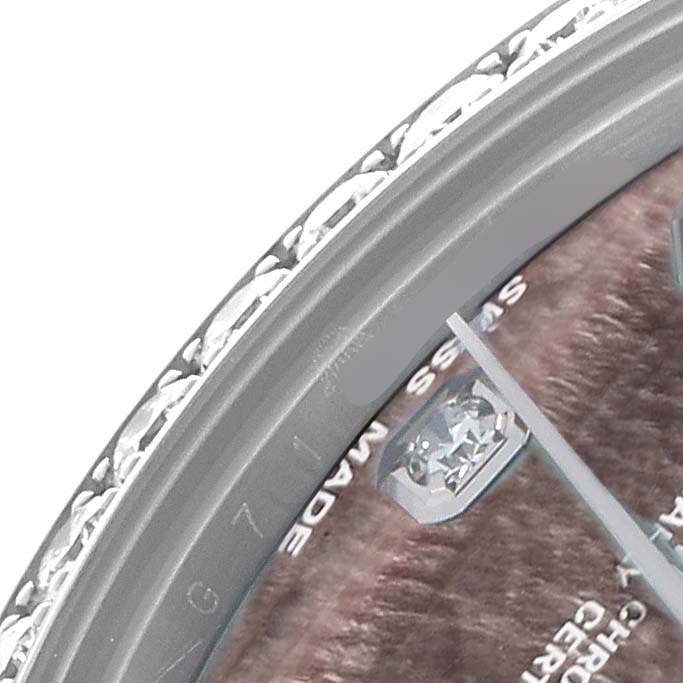 The image shows a close-up of a Rolex Datejust 178384 Women
s Stainless Steel Mother of Pearl Dial watch
s dial, bezel, and part of its crystal.