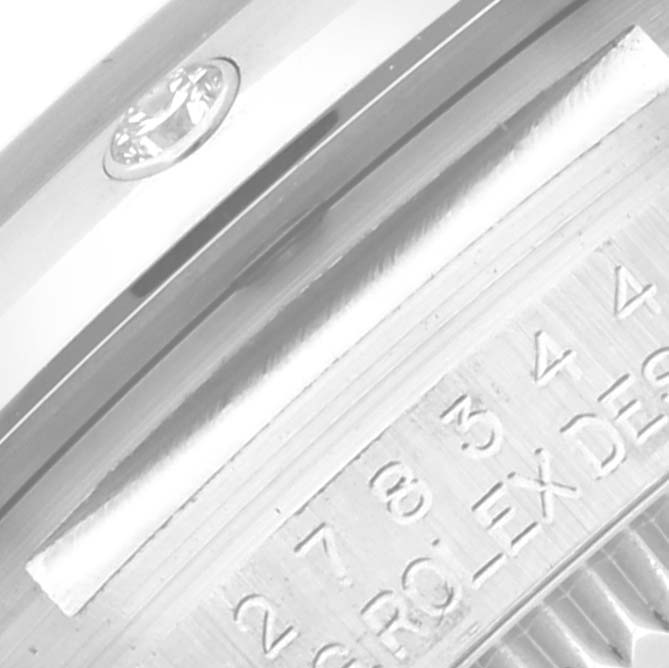 The image shows a close-up of the side of a Rolex Datejust 278344 Women's Stainless Steel Pink Dial 278344 Women's Stainless Steel Pink Dial watch, focusing on the bezel and part of the engraved text on the case.