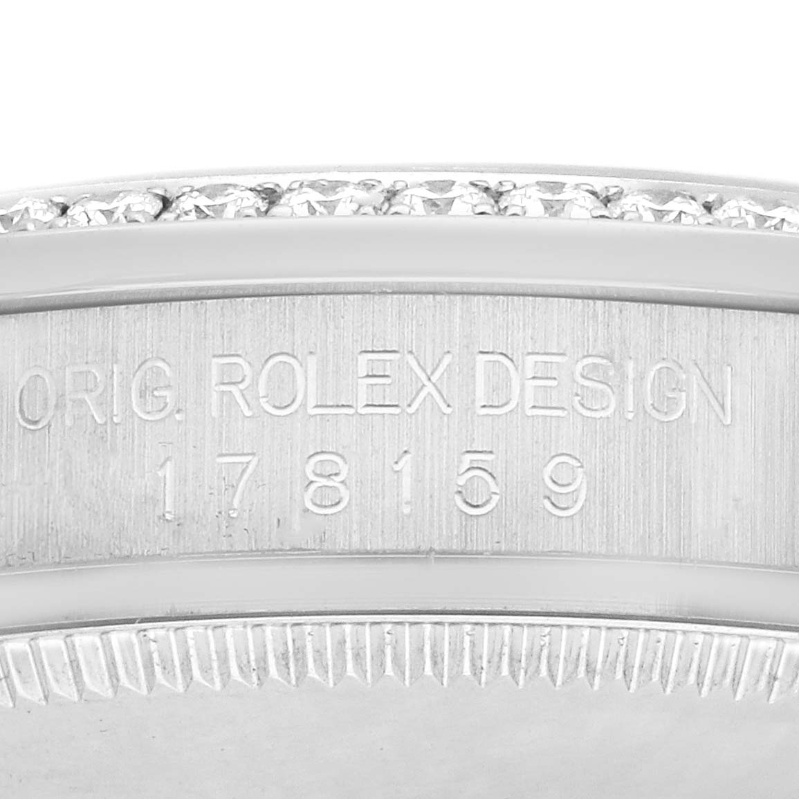 The image shows the side engraving and bezel detail of a Rolex President 178159 Women
s White Gold Mother of Pearl Dial model watch.