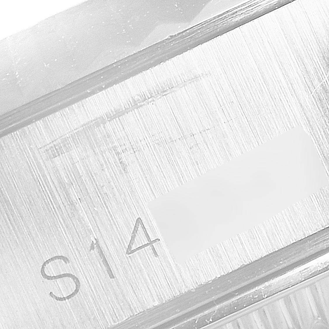 This is a close-up of the Datejust model by Rolex, focusing on the engraved serial number section in the case.
