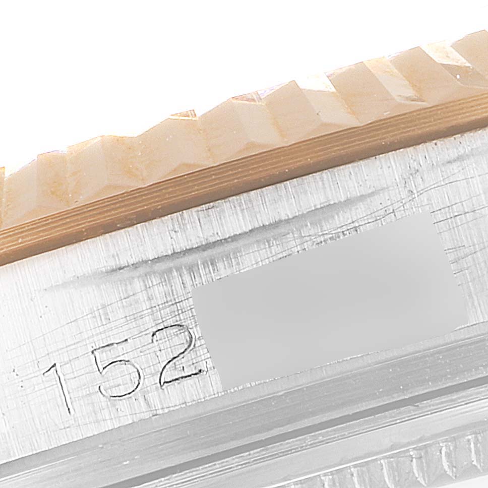 The image shows a close-up of the side view of a Rolex Vintage Collection 1601 Men's Steel and Gold (two tone) Black Dial 1601 Men's Steel and Gold (two tone) Black Dial watch, highlighting its bezel and part of its serial number.