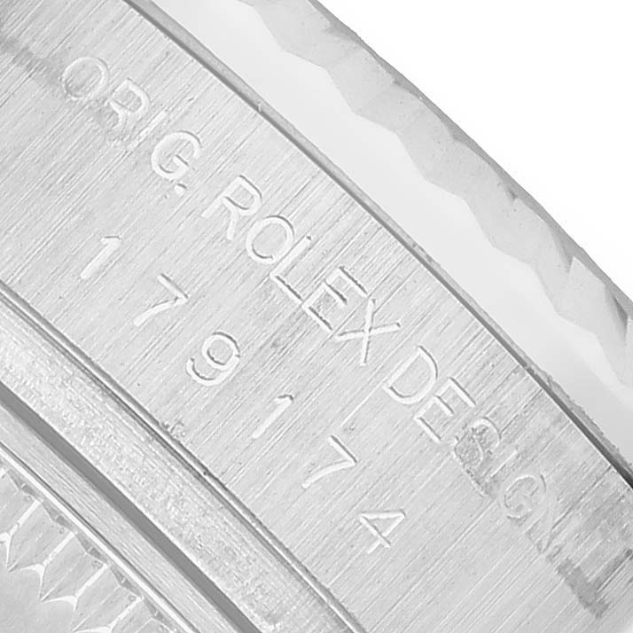 The image shows the engraved side view of a Rolex Datejust 179174 Women's Stainless Steel Black Dial model, focusing on the case with visible design numbers.