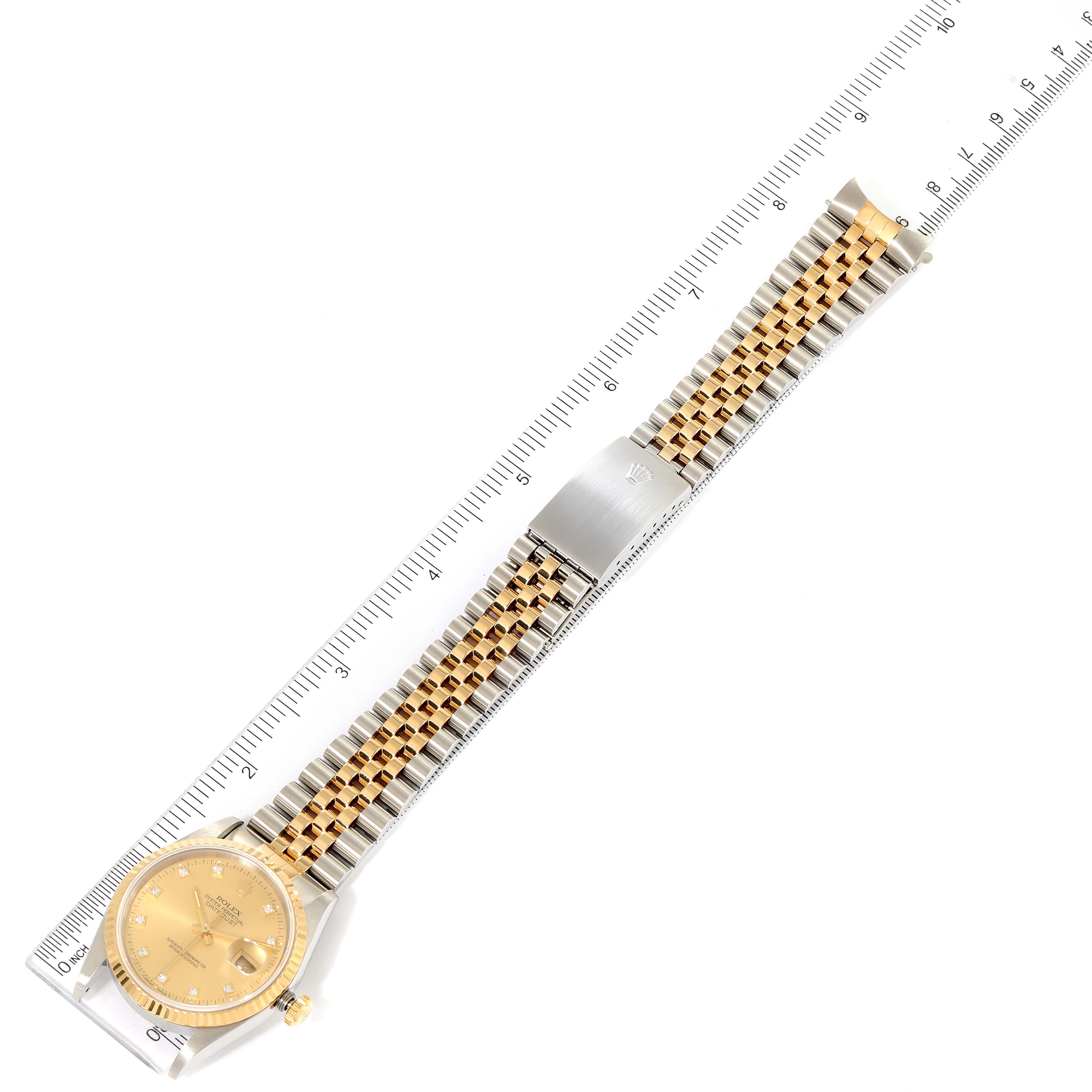 The image shows a top-down view of a Rolex Datejust 16233 Men's Steel and Gold (two tone) Champagne Dial 16233 Men's Steel and Gold (two tone) Champagne Dial watch, highlighting its gold and silver bracelet, clasp, and the watch face with a ruler for scale.