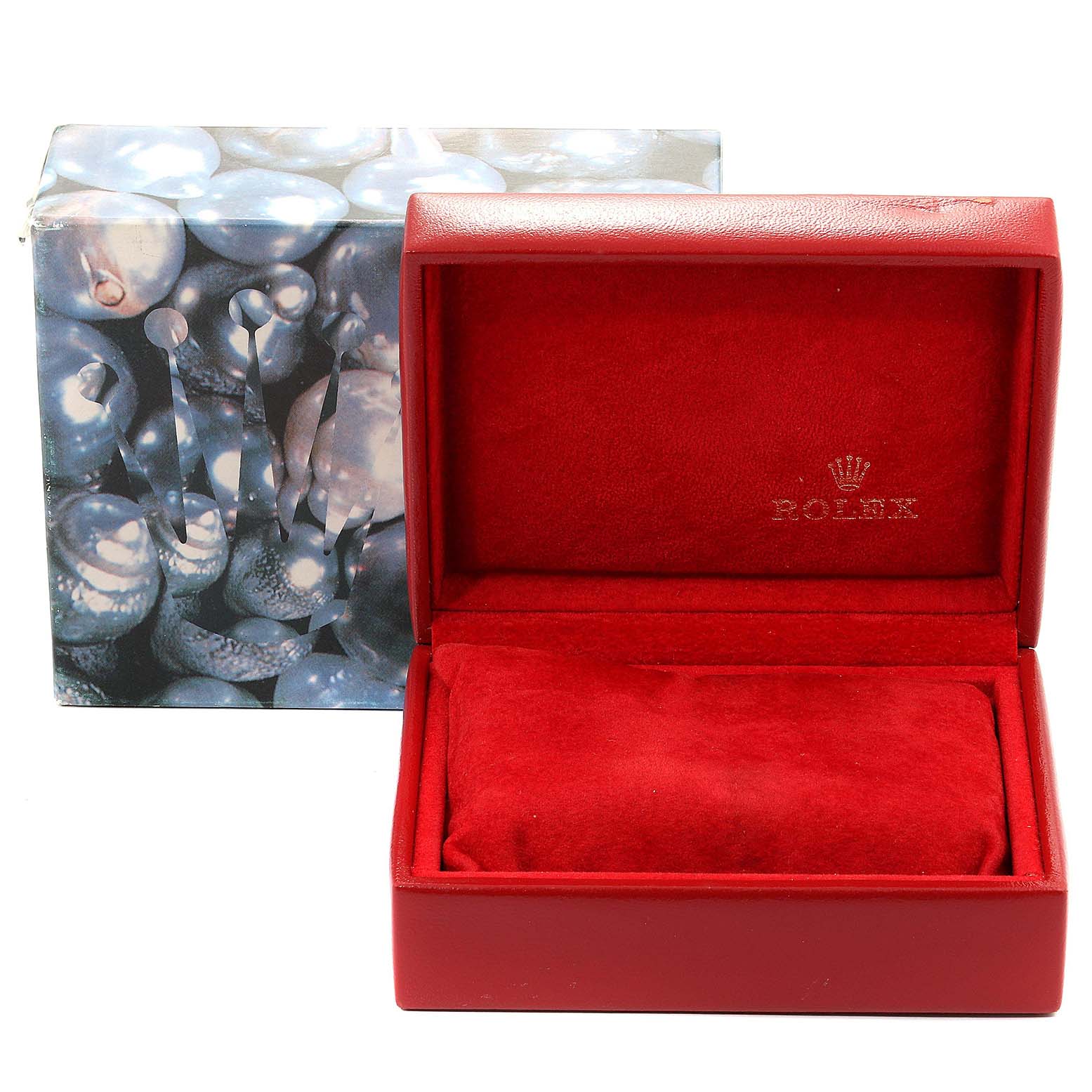 The image shows an empty red Rolex Datejust 79173 Women's Steel and Gold (two tone) Champagne Dial 79173 Women's Steel and Gold (two tone) Champagne Dial watch box with a cushioned interior and closed outer packaging in the background.