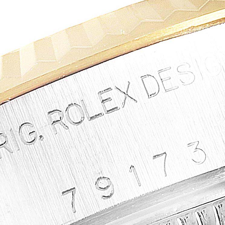 The image shows a close-up of the bezel and engraved serial number on a Rolex Datejust 79173 Women's Steel and Gold (two tone) Champagne Dial 79173 Women's Steel and Gold (two tone) Champagne Dial watch.