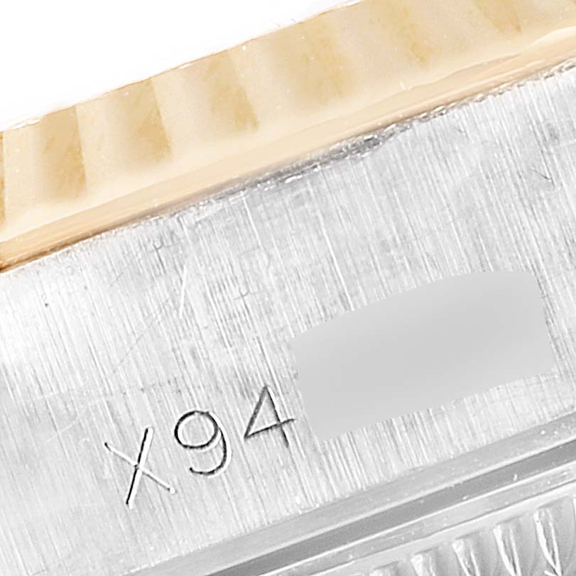 This image shows a close-up of the bezel and case with visible engravings on a Rolex Datejust 69173 Women
s Steel and Gold (two tone) Silver Dial 69173 Women
s Steel and Gold (two tone) Silver Dial watch.