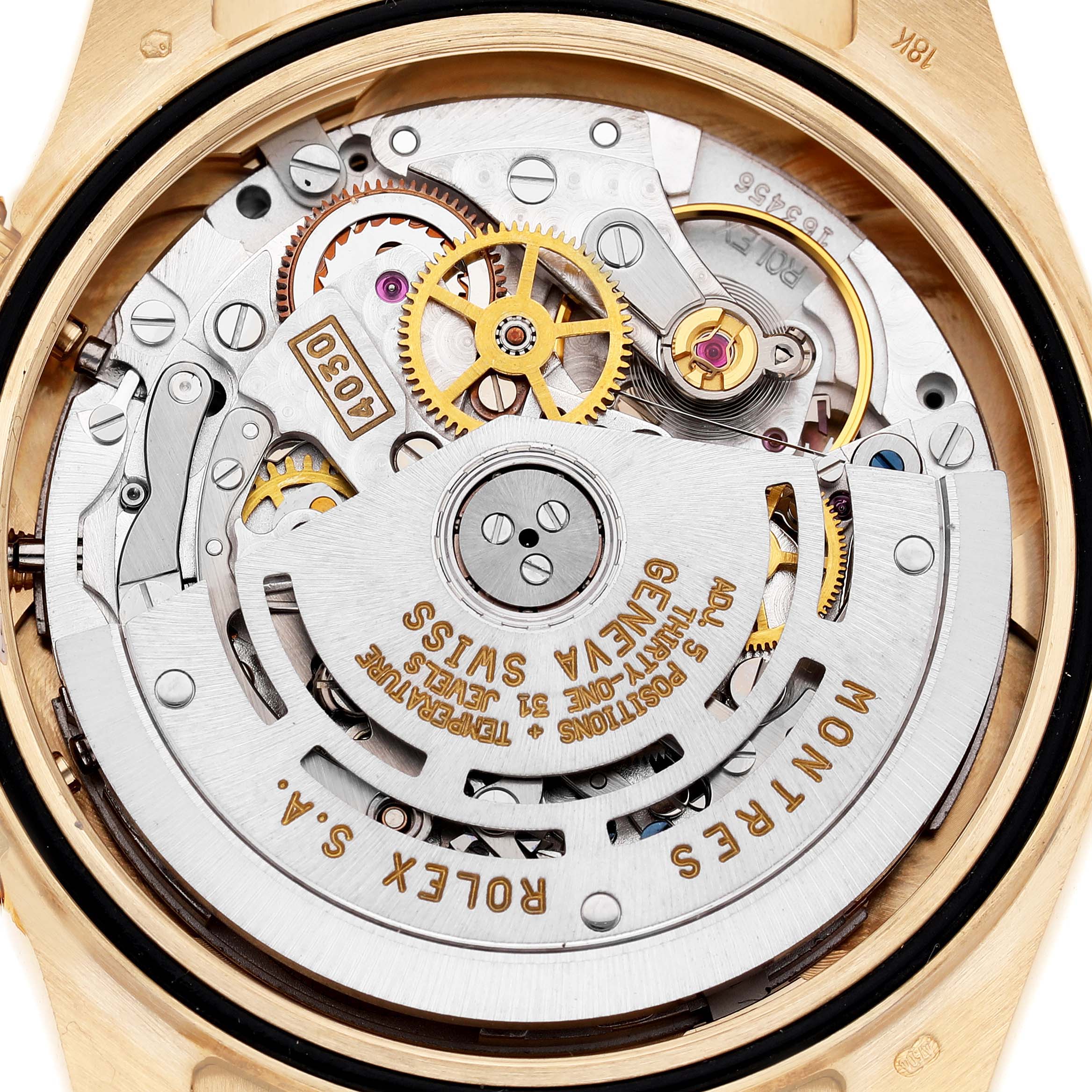 The image shows the intricate movement of a Rolex Daytona 16518 Men's Yellow Gold White Dial watch, highlighting gears and the rotor from the back.