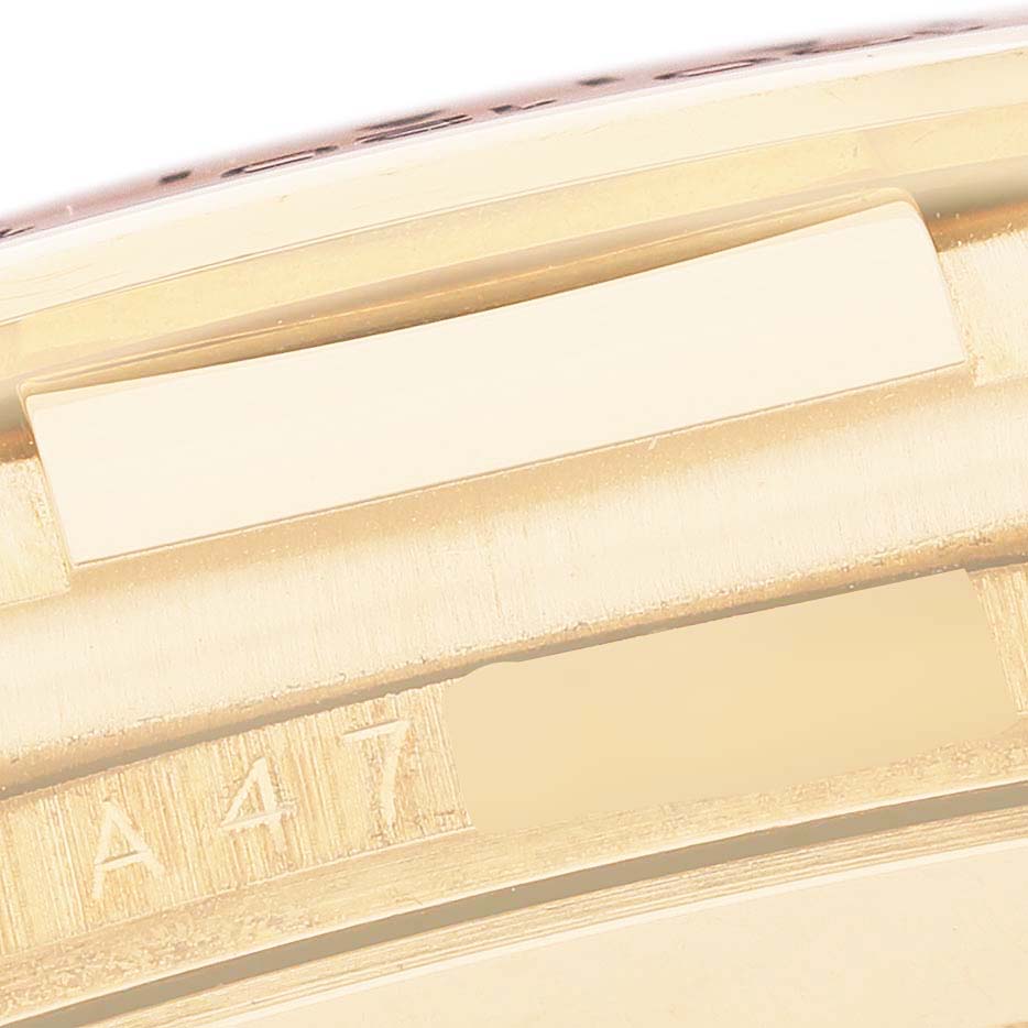 The image shows a close-up of the Rolex Daytona 16518 Men's Yellow Gold White Dial's case side, highlighting the serial number engraving.