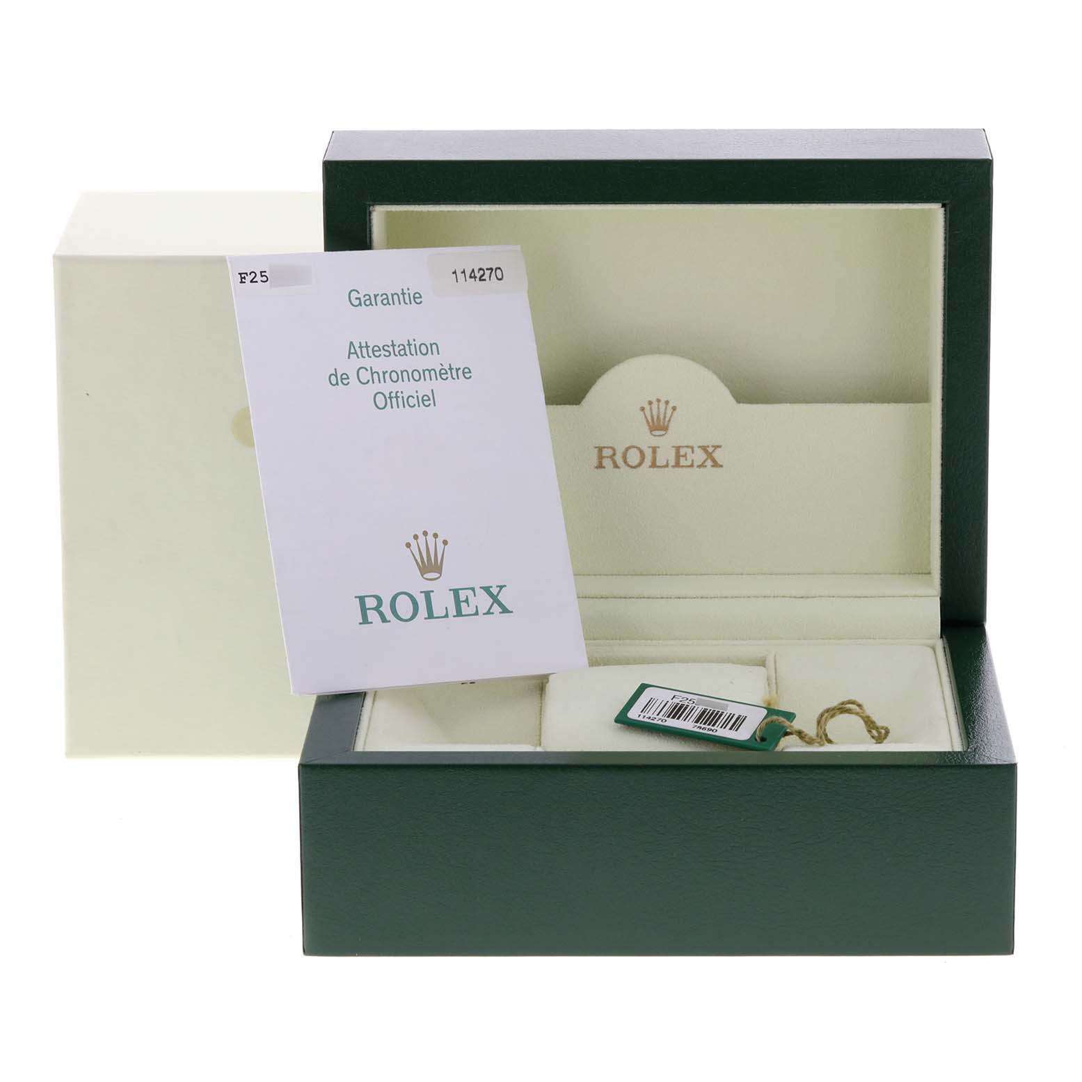 Open box with Rolex Explorer 114270 Men's Stainless Steel Black Dial 114270 Men's Stainless Steel Black Dial model papers, a tag, and a booklet displayed.