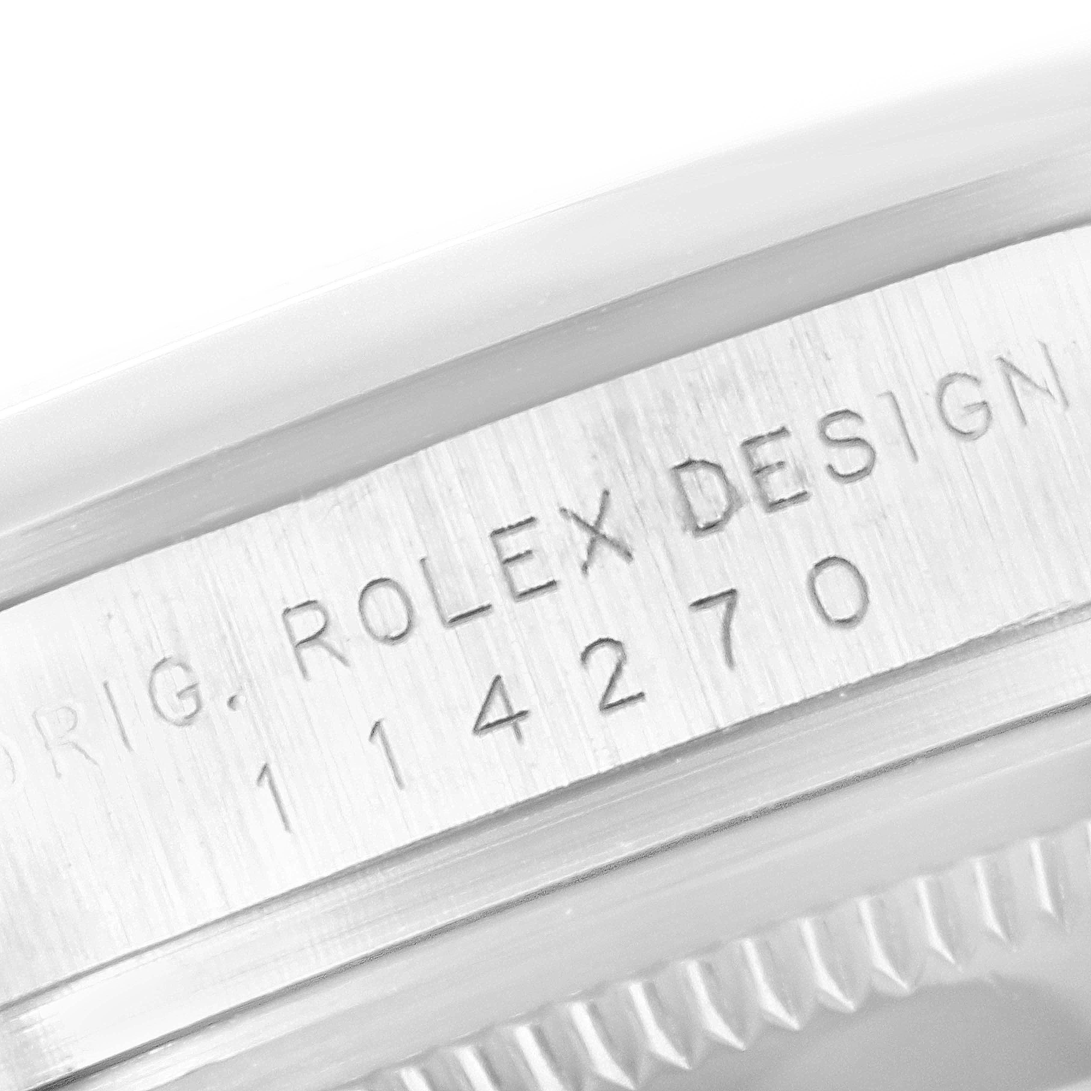 This image shows a close-up of the serial number engraving on the case of a Rolex Explorer 114270 Men's Stainless Steel Black Dial 114270 Men's Stainless Steel Black Dial watch.