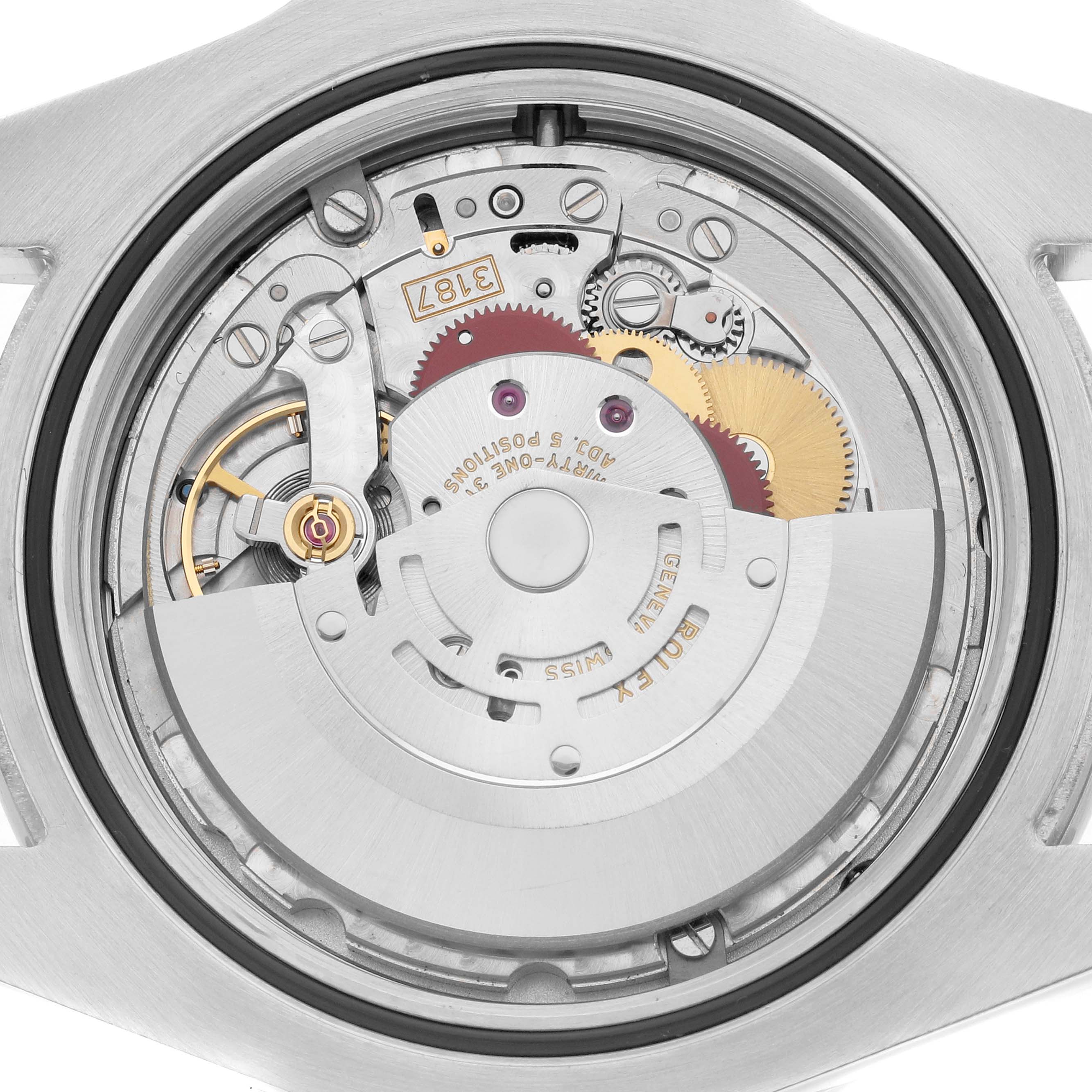 The image shows the movement and internal mechanism of the Rolex Explorer 216570 Men
s Stainless Steel Black Dial watch from a top-down angle.