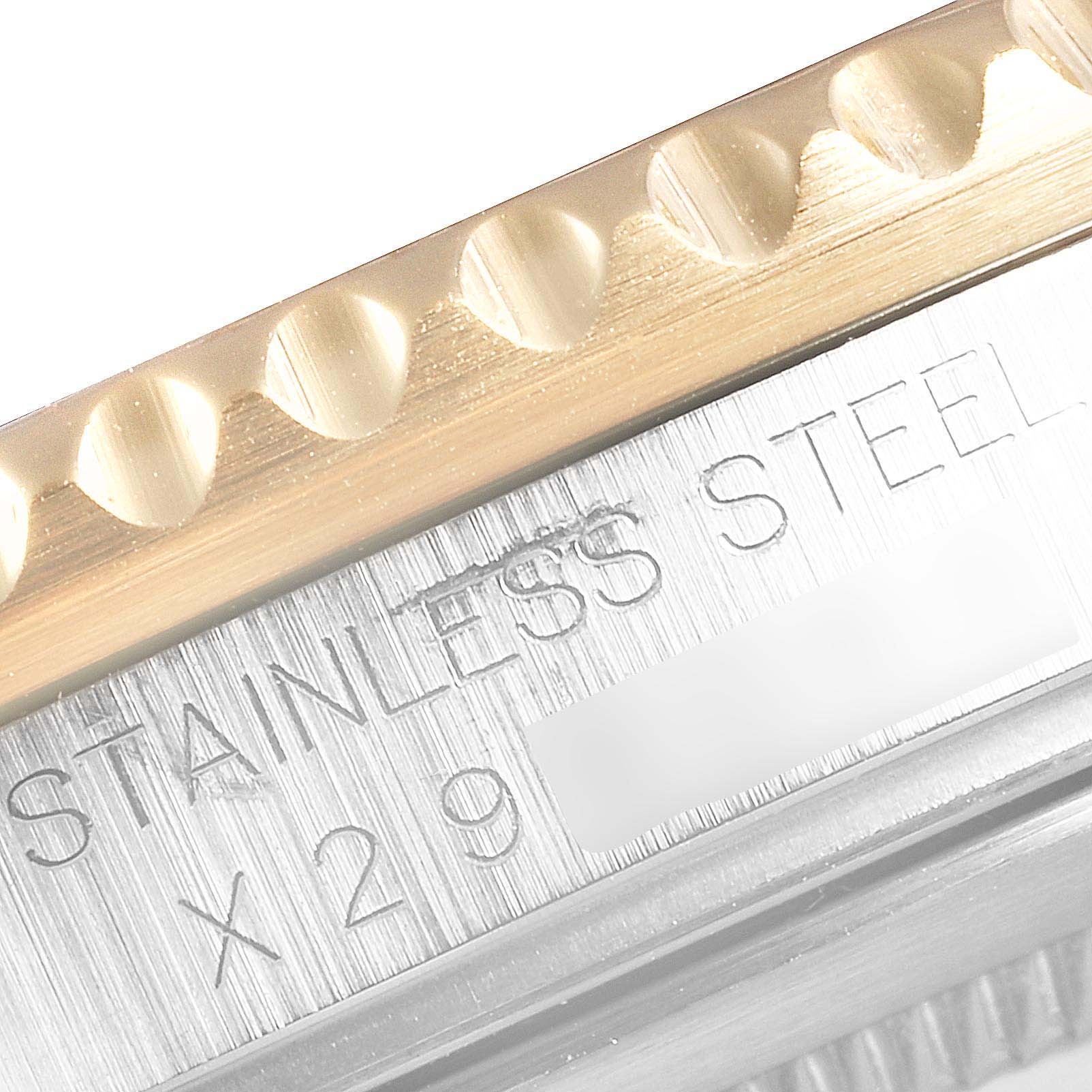 This close-up image shows the engraved stainless steel and part of the bezel of a Rolex GMT-Master 16713 Men's Steel and Gold (two tone) Black Dial 16713 Men's Steel and Gold (two tone) Black Dial watch.