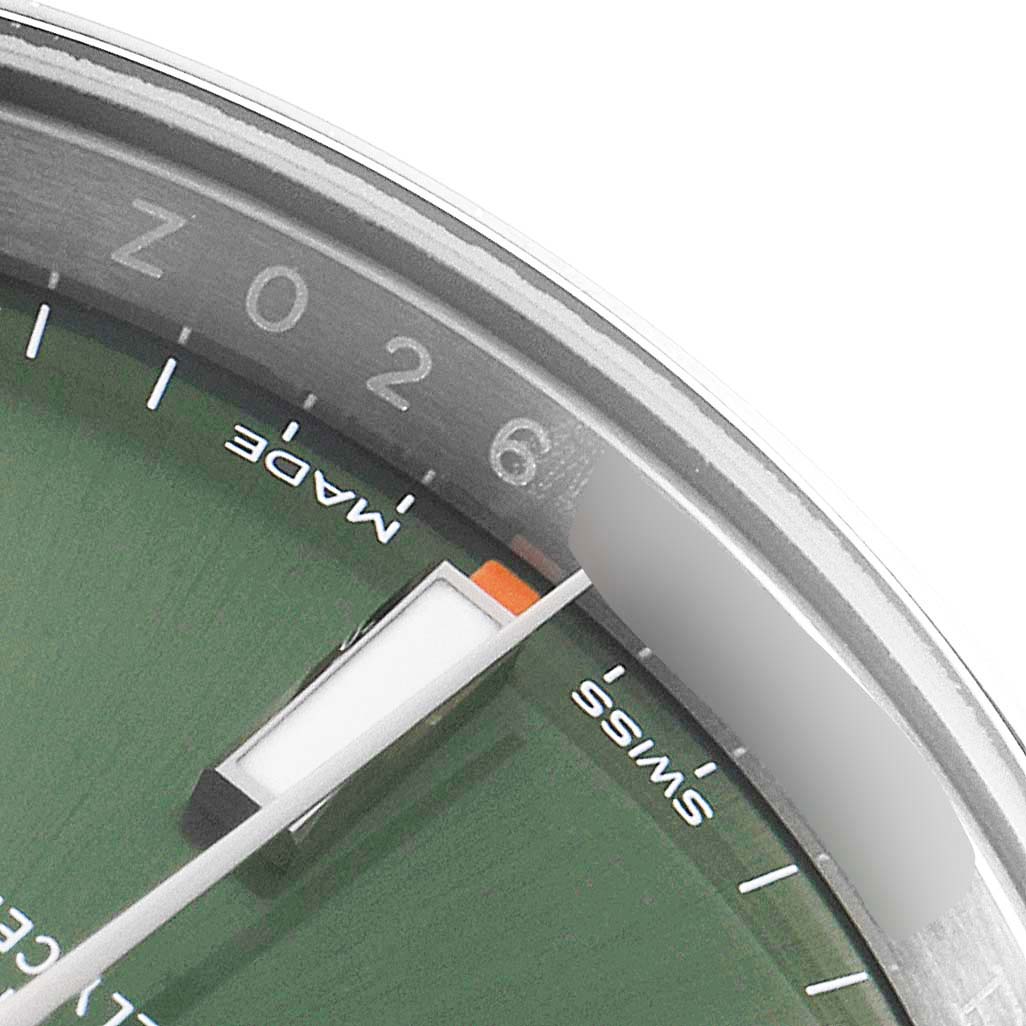 The image shows a close-up of the dial, bezel, and minute hand of a Rolex Oyster Perpetual 114200 Men's Stainless Steel Green Dial 114200 Men's Stainless Steel Green Dial watch.