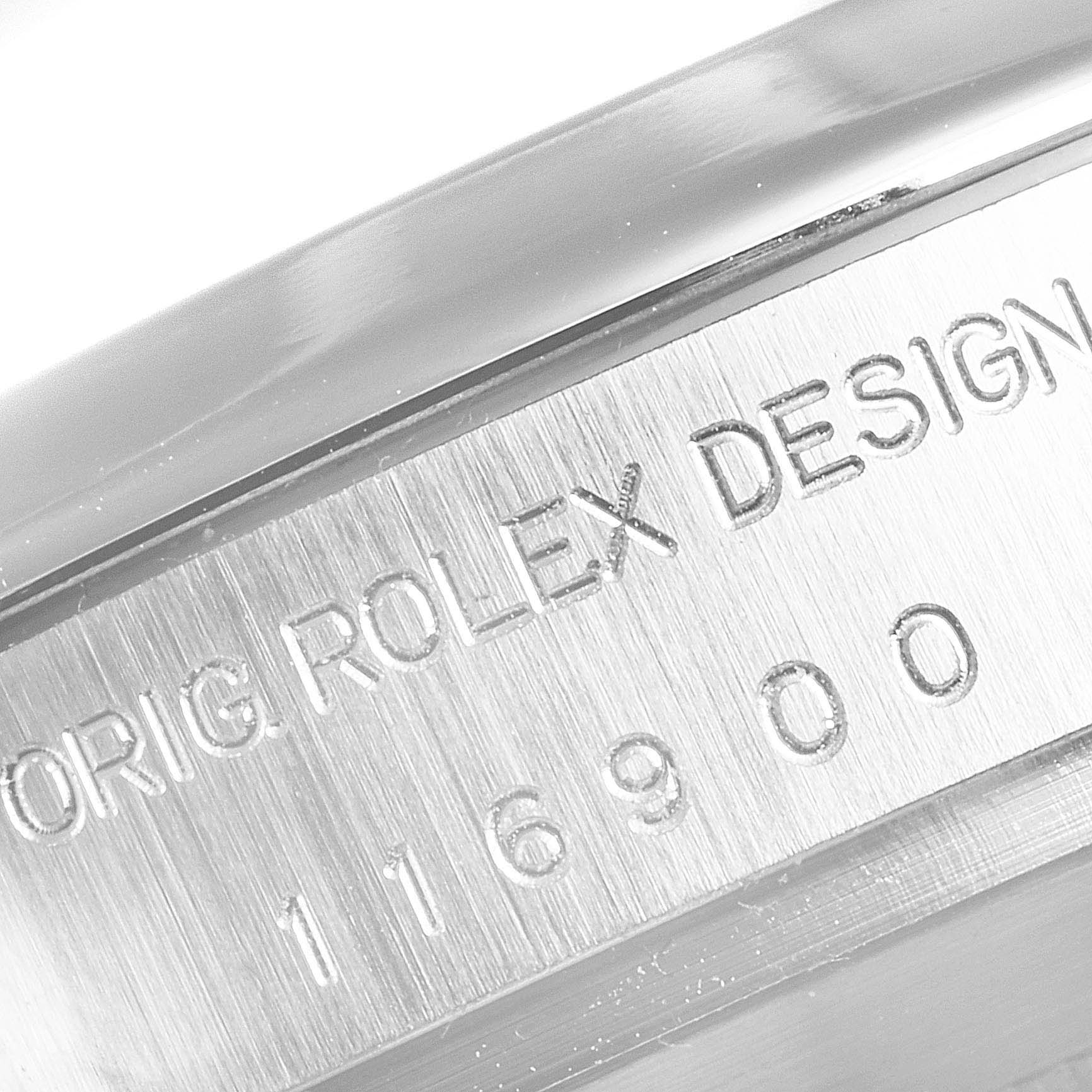 The image shows a close-up of the side of a Rolex Air-King 116900 Men's Stainless Steel Black Dial 116900 Men's Stainless Steel Black Dial watch, focusing on the engraved serial number.