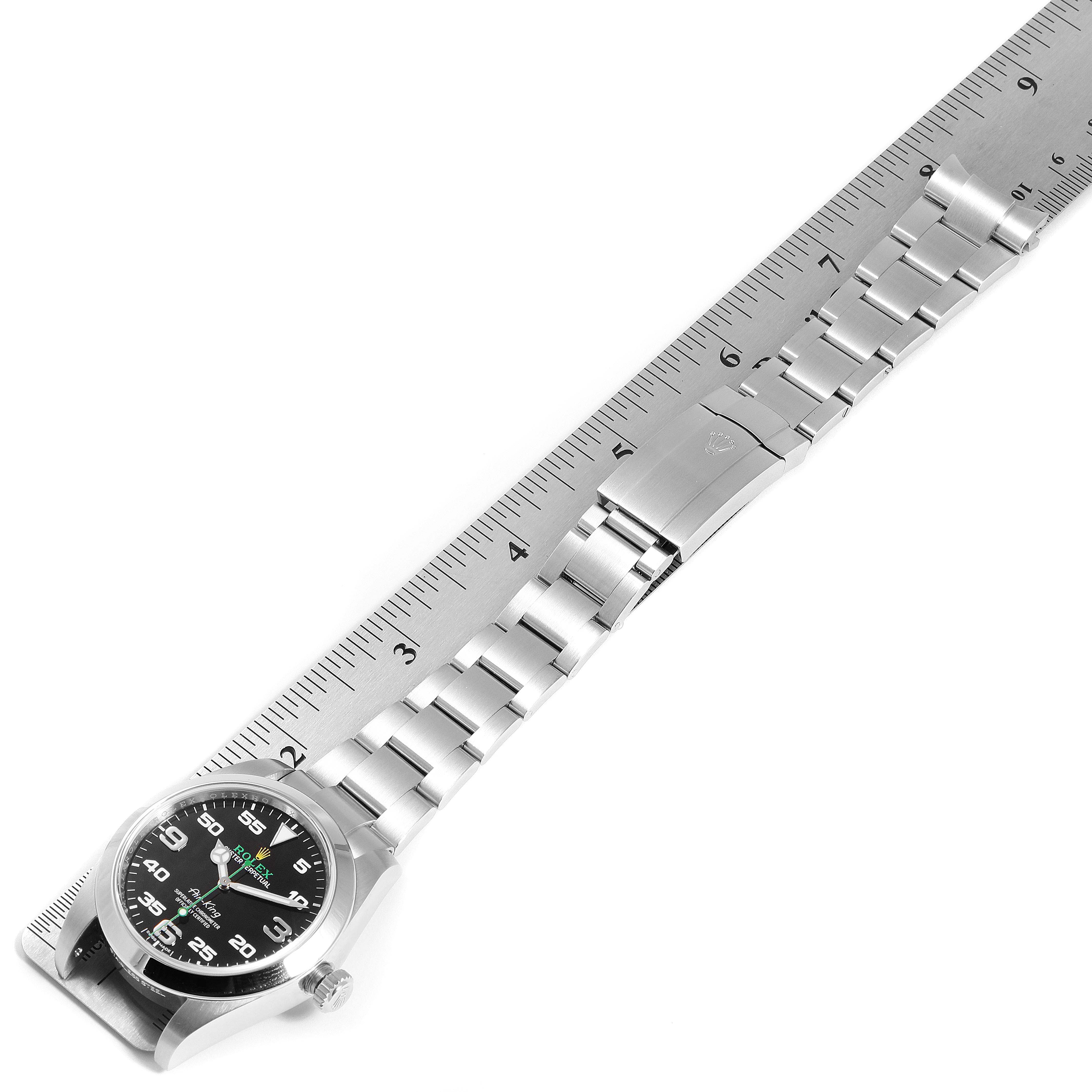The image shows an overhead view of the Rolex Air-King 116900 Men's Stainless Steel Black Dial 116900 Men's Stainless Steel Black Dial watch, highlighting its black dial, stainless steel bracelet, and clasp.