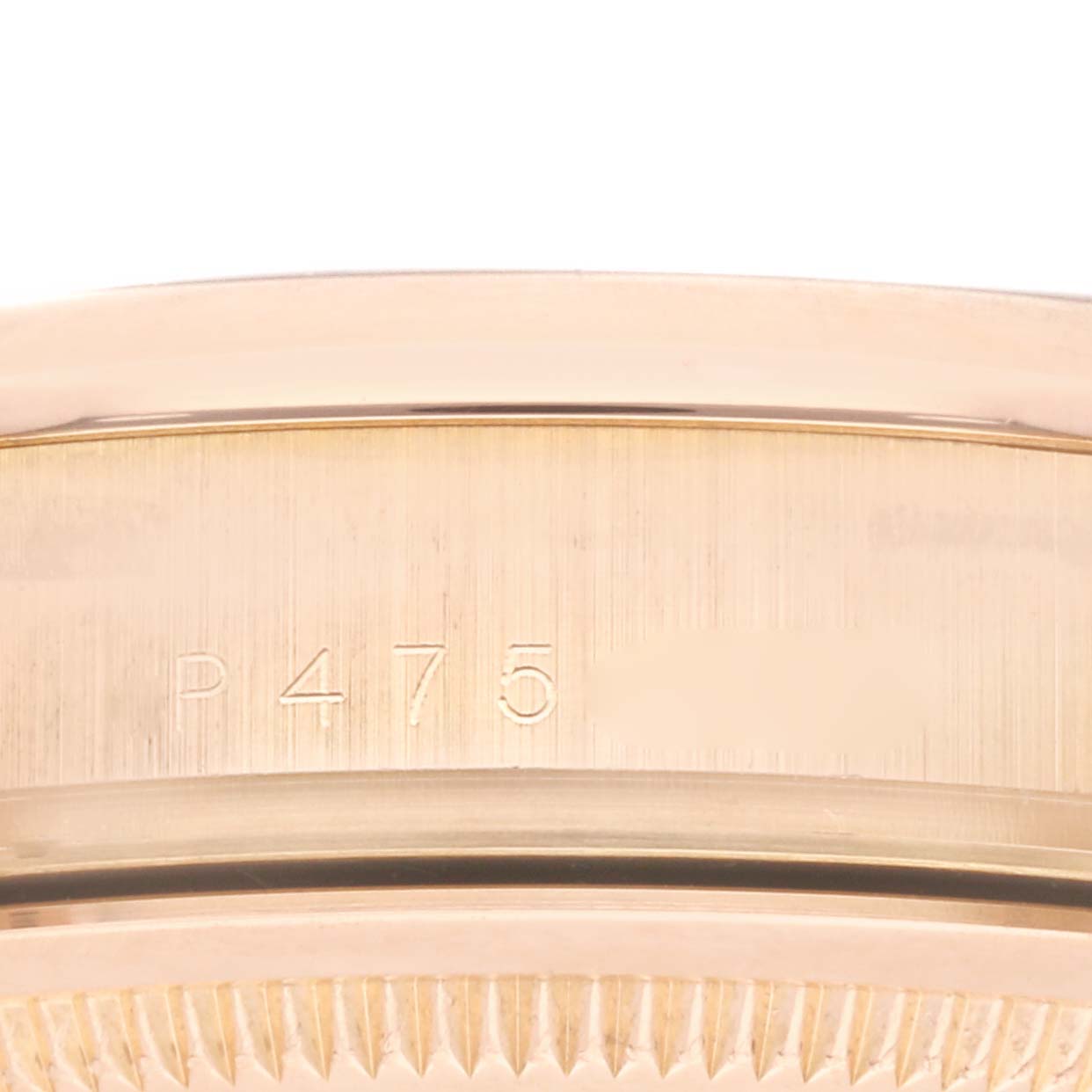 This is a close-up of the side of a Rolex President 118205 Men's Rose Gold White Dial 118205 Men's Rose Gold White Dial model watch, focusing on the case with an engraved "P475" marking.