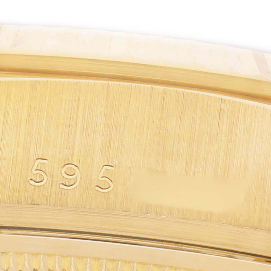 The image shows a close-up of the side of a Rolex President 18038 Men's Yellow Gold Champagne Dial watch, focusing on the engraved numbers and gold texture.