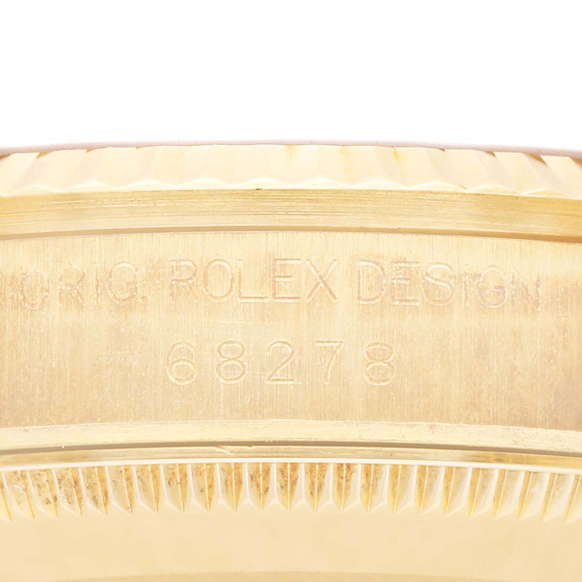 This close-up image shows the side engraving on the bezel of a Rolex President 68278 Women's Yellow Gold Champagne Dial 68278 Women's Yellow Gold Champagne Dial model watch.
