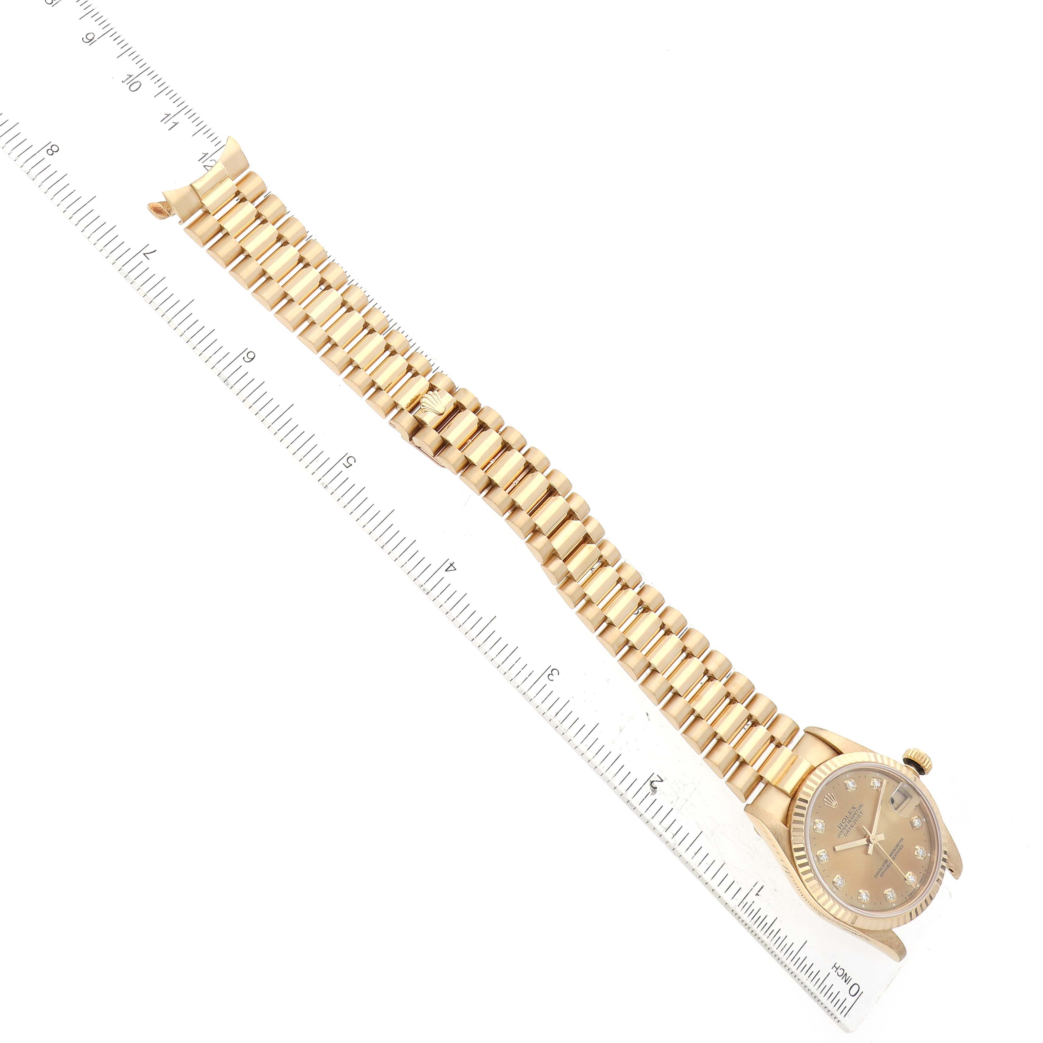 The image shows the Rolex President 68278 Women's Yellow Gold Champagne Dial 68278 Women's Yellow Gold Champagne Dial model watch laid flat, with the bracelet and dial visible, alongside a ruler for scale.