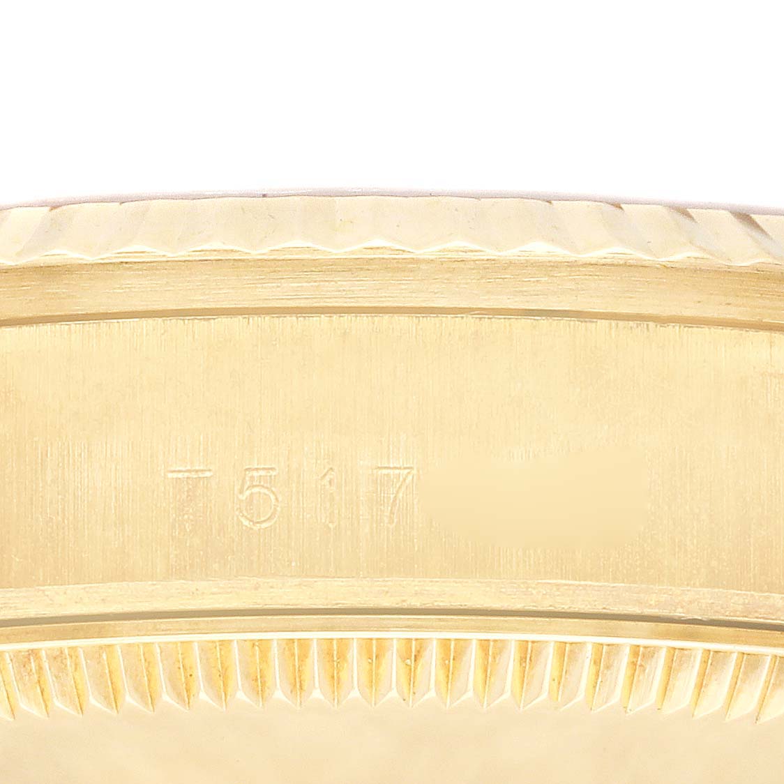 This image shows a close-up of the gold case's edge and part of the fluted bezel of a Rolex President 68278 Women's Yellow Gold Champagne Dial 68278 Women's Yellow Gold Champagne Dial model.