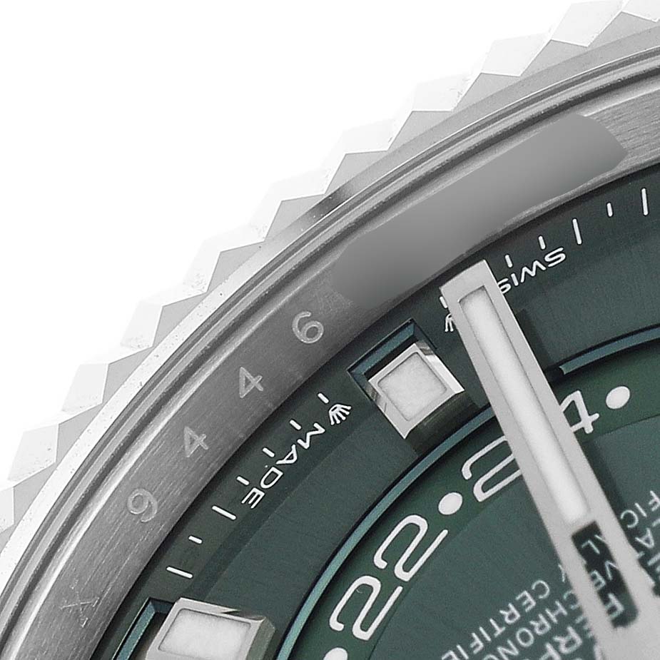 The image shows a close-up of the Rolex Sky-Dweller 336934 Men's Stainless Steel Green Dial's bezel, part of the dial, and hour markers.