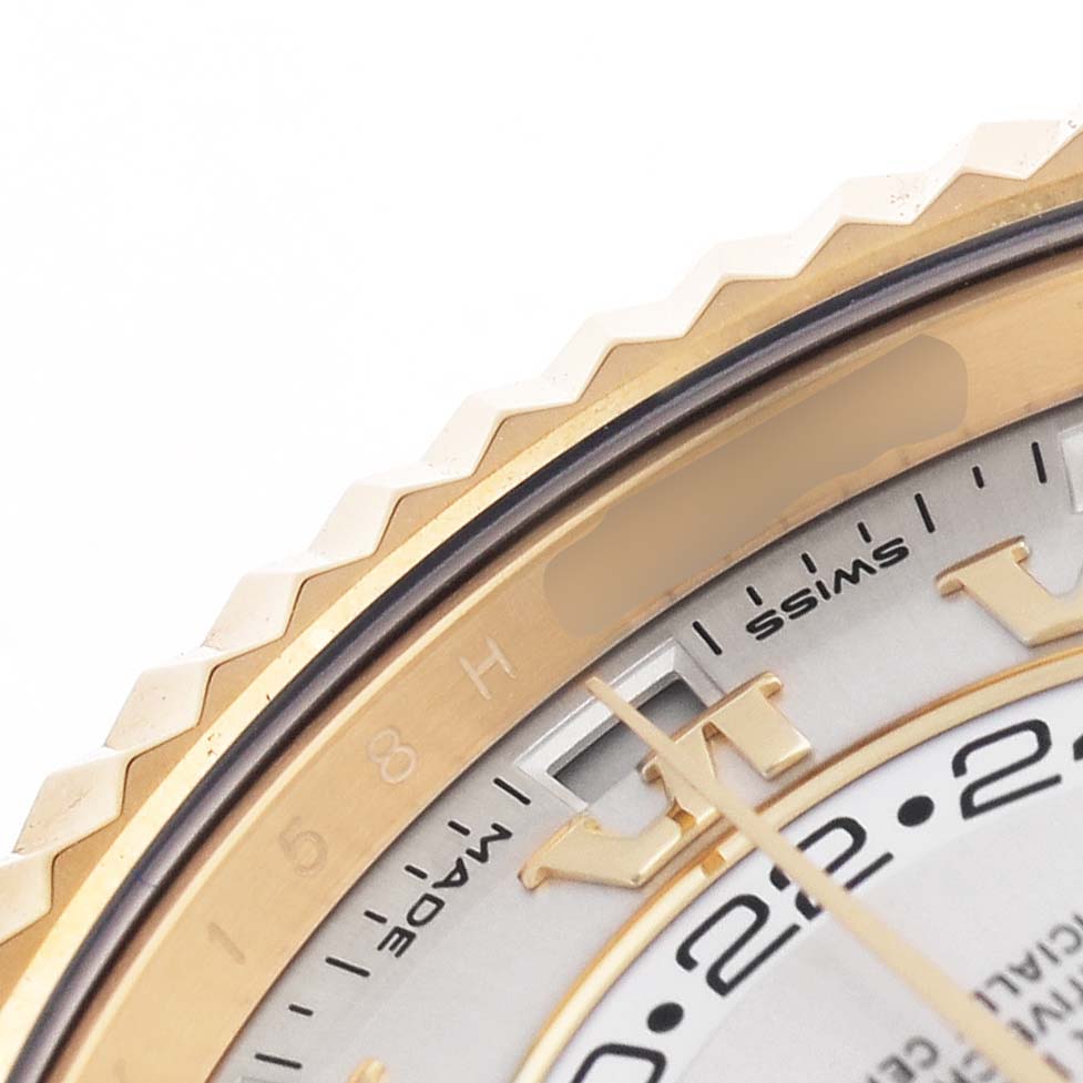 The image shows a close-up of the gold bezel, hour markers, and part of the dial of a Rolex Sky-Dweller 326938 Men's Yellow Gold Silver Dial watch.
