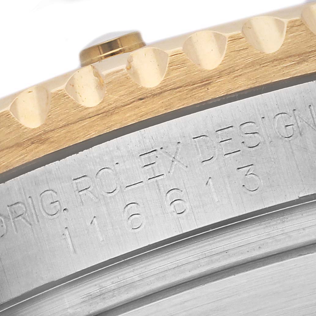This image shows a close-up of the case edge and bezel, revealing the model number of the Rolex Submariner 116613 Men's Steel and Gold (two tone) Black Dial 116613 Men's Steel and Gold (two tone) Black Dial.