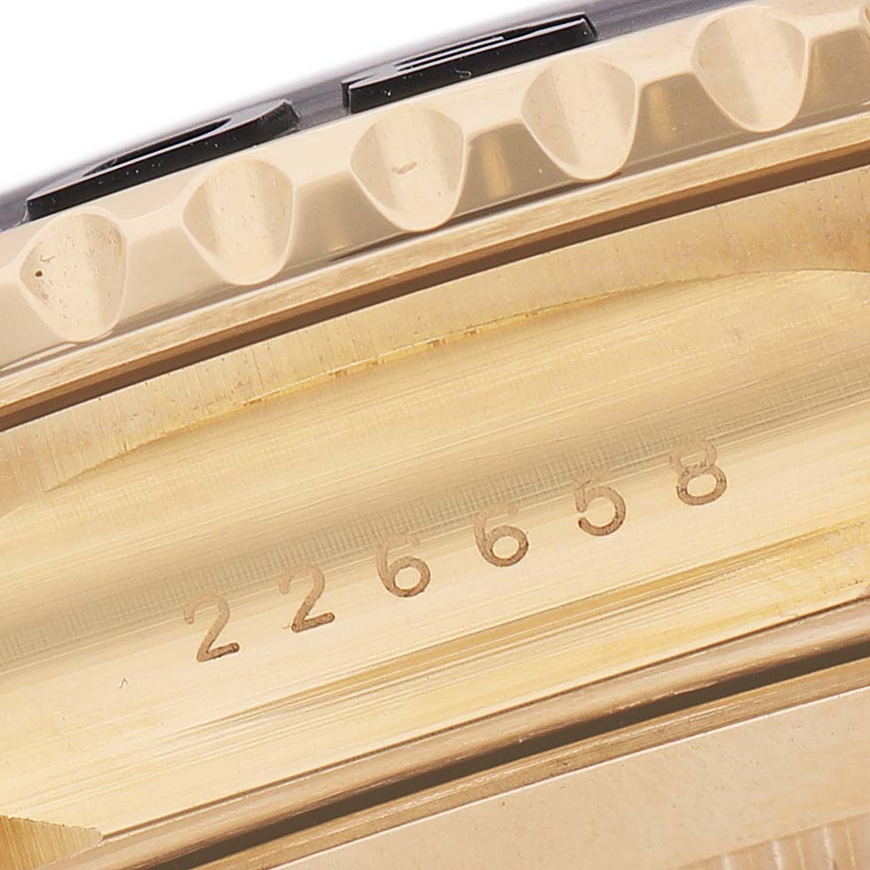 The image shows a close-up of the bezel and case side of a Rolex Yacht-Master 226658 Men's Yellow Gold Black Dial watch, featuring its serial number.