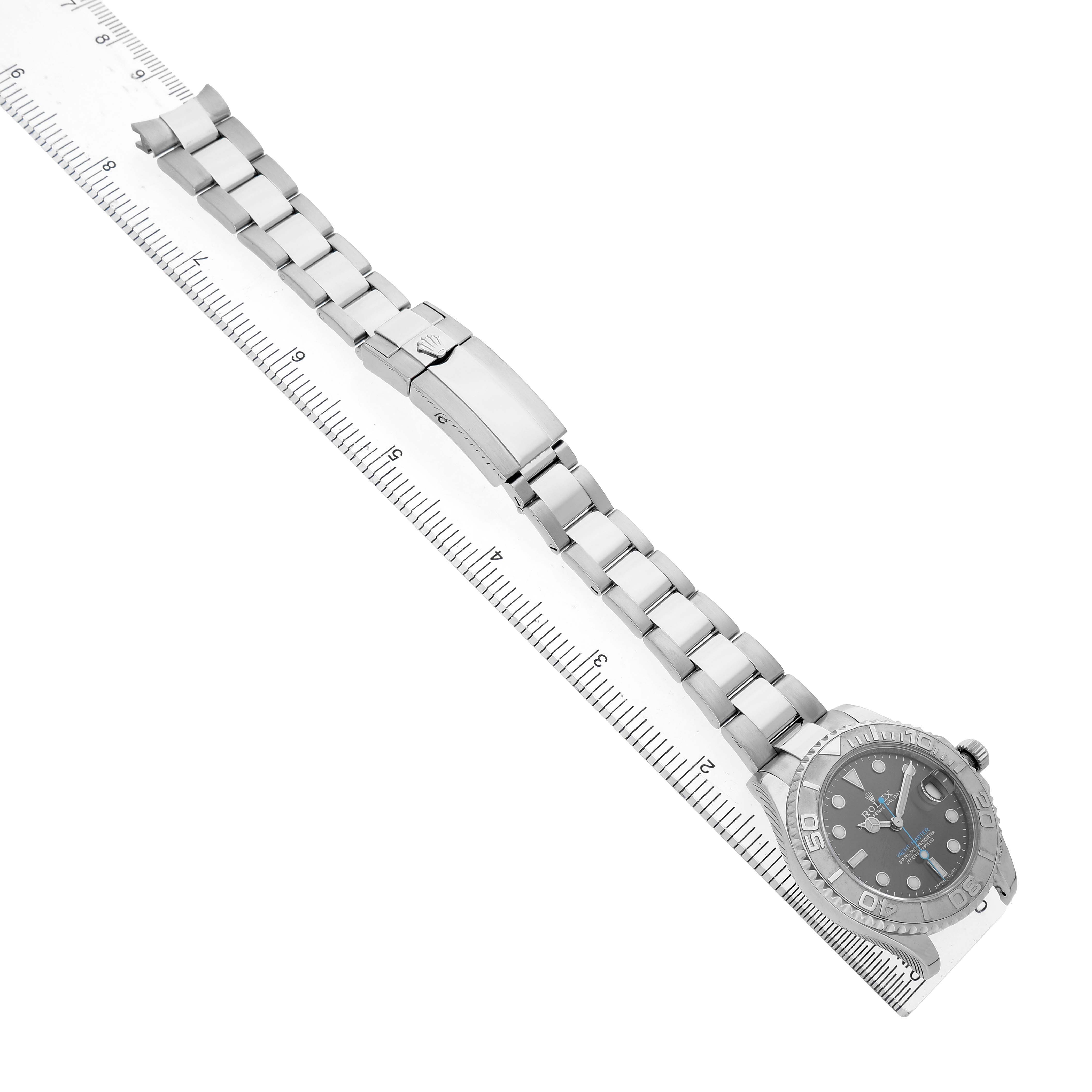 The Rolex Yacht-Master 268622 Men's Stainless Steel Silver Dial watch is shown from an angled top view, showcasing the full bracelet, clasp, and watch face with a ruler for scale.