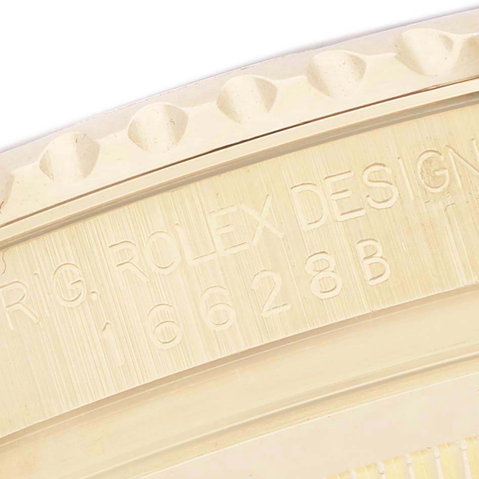 The image shows a close-up of the engraved bezel edge of a Rolex Yacht-Master 16628B Men
s Yellow Gold Mother of Pearl Dial watch.
