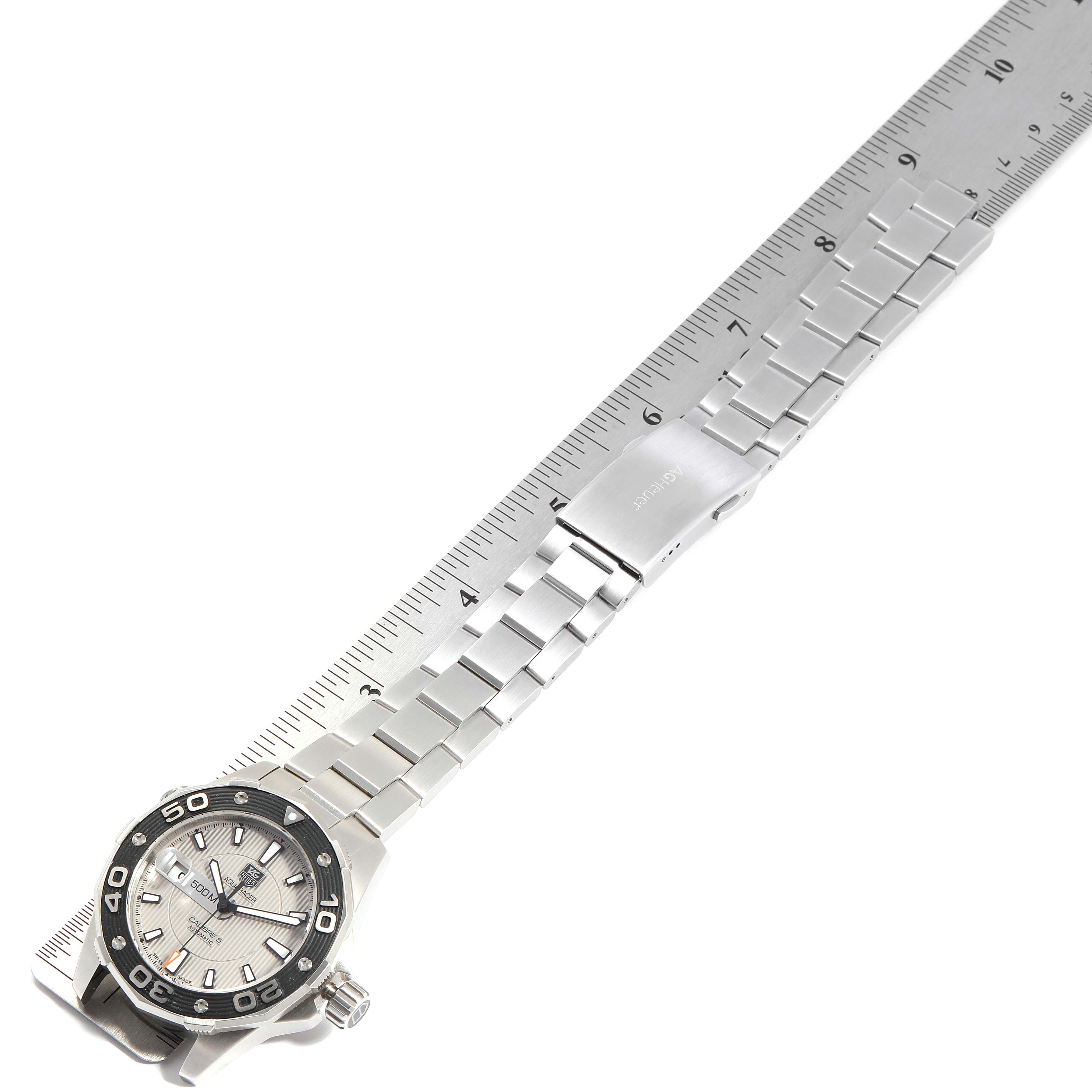 The image shows a Tag Heuer Aquaracer WAJ2111.BA0870 Men's Stainless Steel Grey Dial WAJ2111.BA0870 Men's Stainless Steel Grey Dial watch laid flat with the face and metal band visible next to a ruler for measurement.