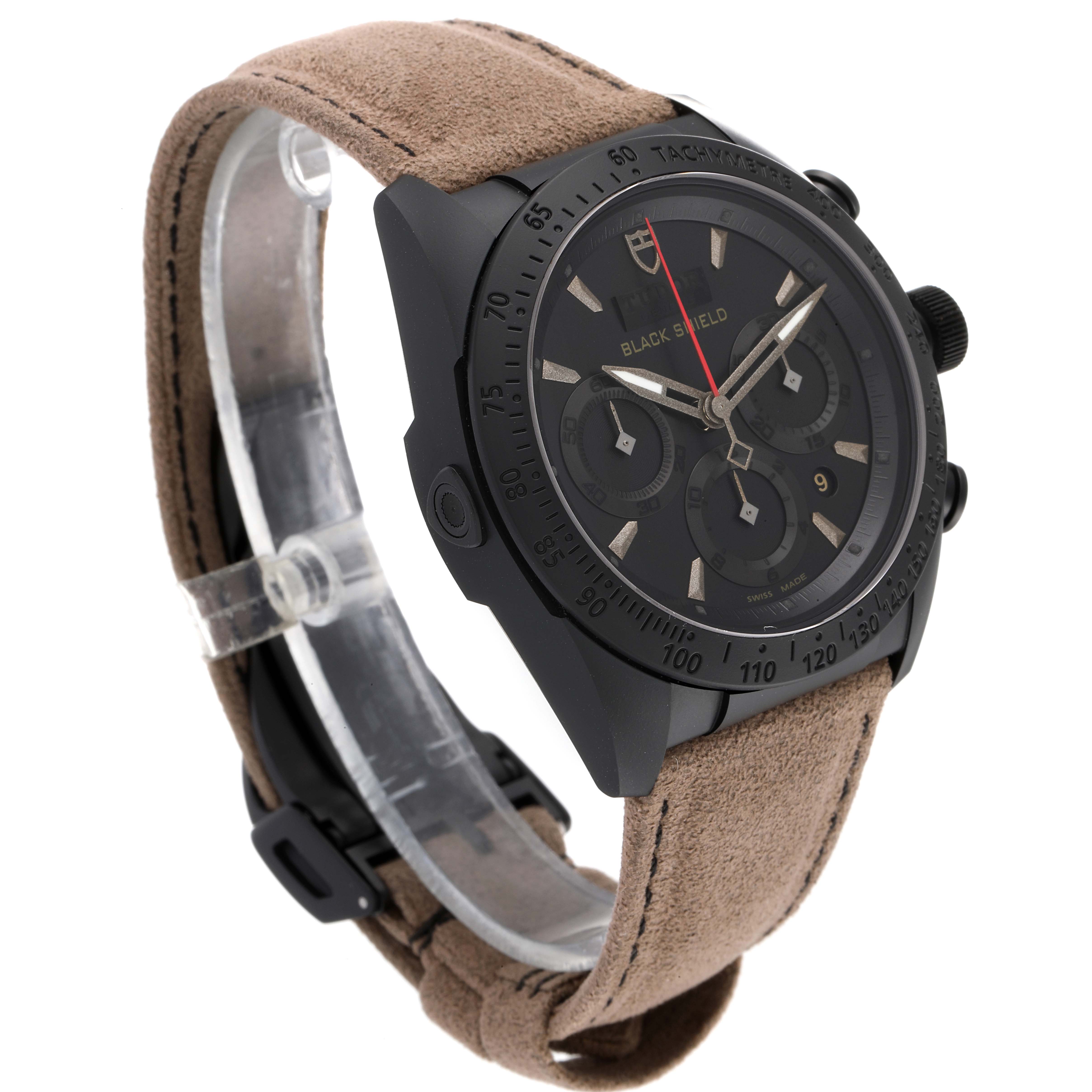 The image shows a Tudor Fastrider 42000CN Men's Ceramic Black Dial 42000CN Men's Ceramic Black Dial watch at a 45-degree angle, highlighting its dial, case, pushers, and suede strap.