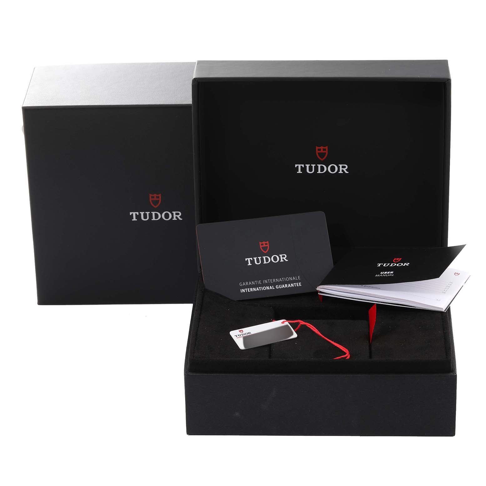 The image shows the packaging, international guarantee card, and booklets for the Tudor Heritage Black Bay 7941A1A0NU Men's Stainless Steel Black Dial 7941A1A0NU Men's Stainless Steel Black Dial model watch.